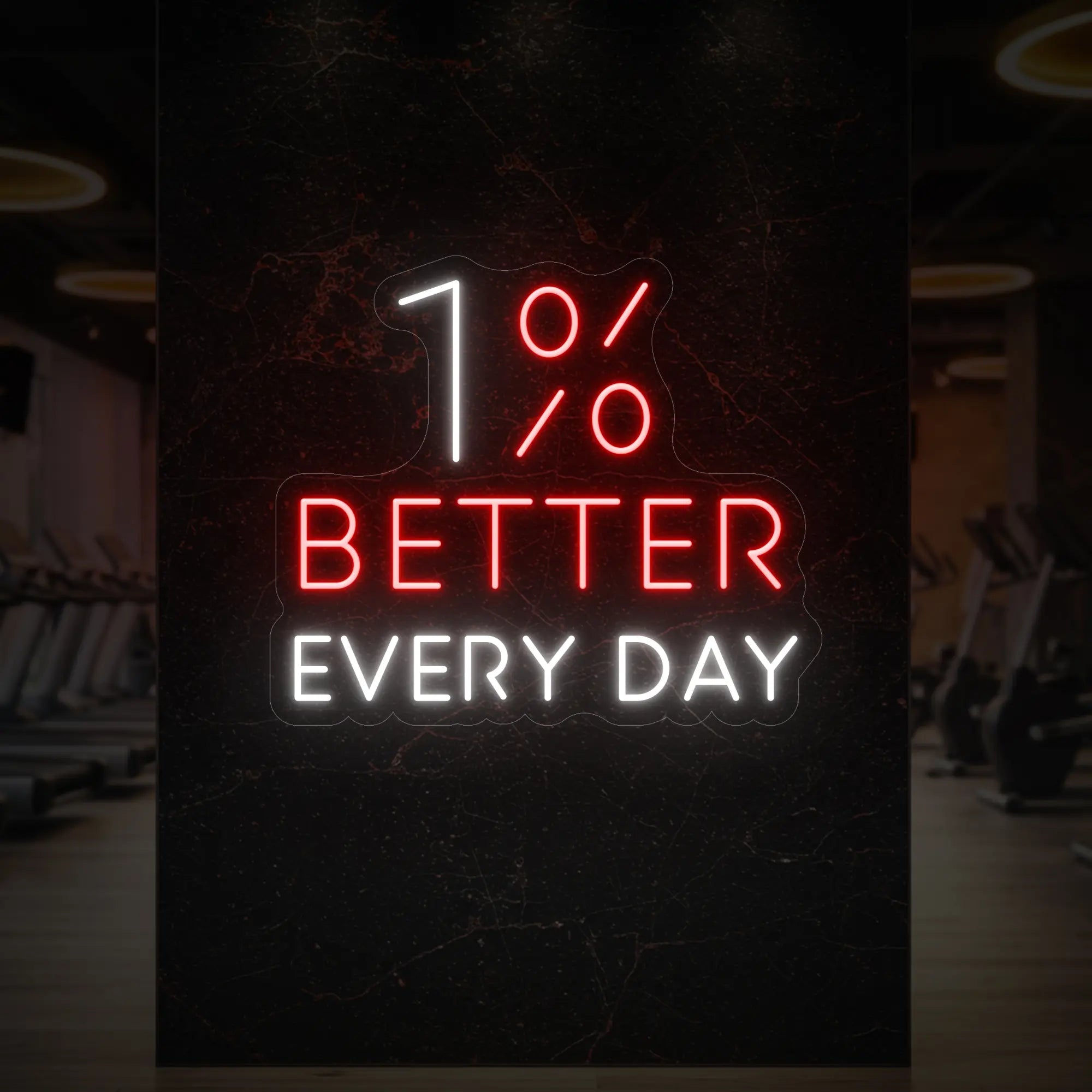 '1% Better Every Day' neon sign glowing in red and cool white against a styled interior wall.