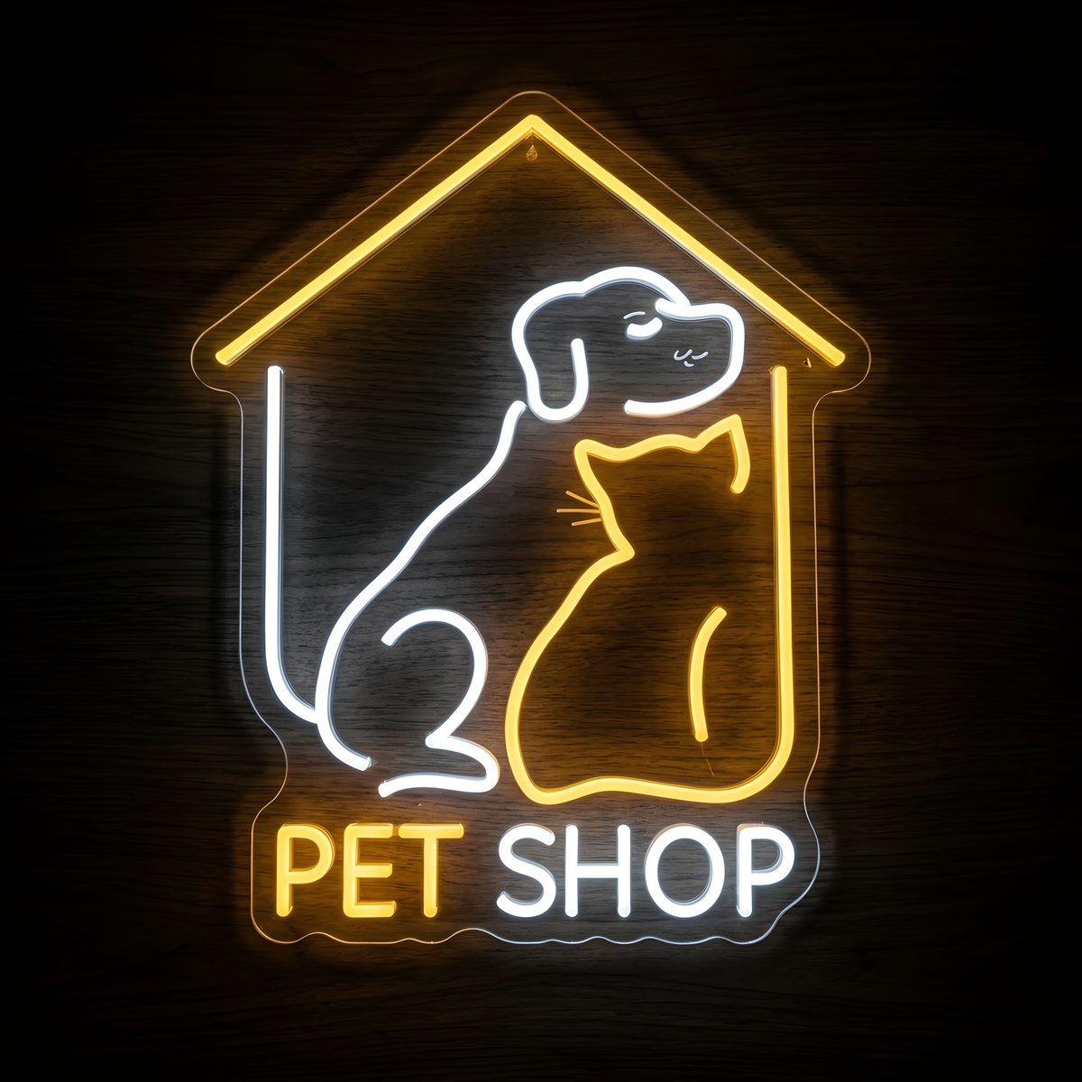 Home Pet Shop LED Neon Sign featuring a white dog and warm yellow cat sitting inside a glowing house outline with Pet Shop lettering, displayed on clear acrylic against a dark wood wall for pet stores, animal boutiques, and pet care businesses.