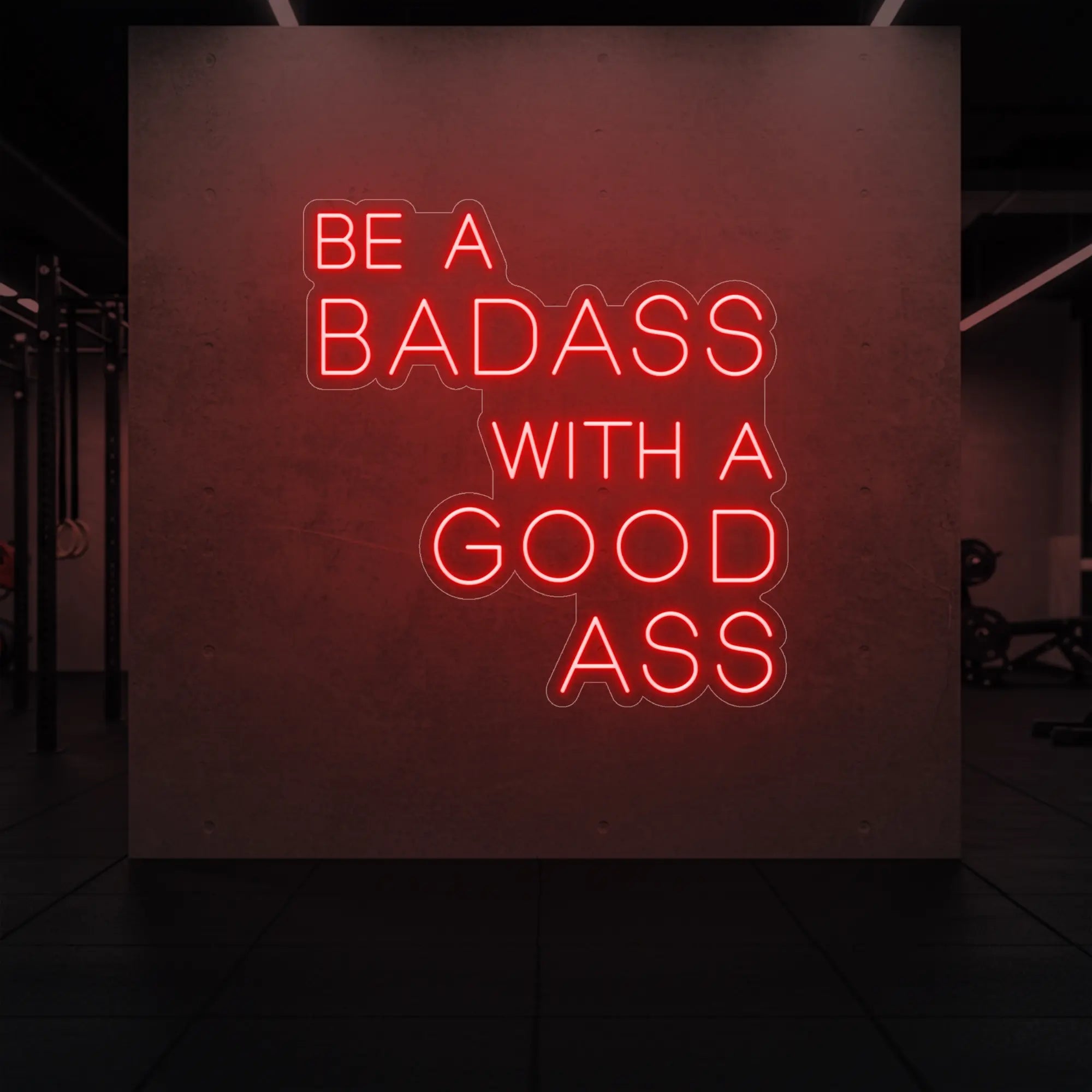 'Be a Badass With a Good Ass' neon sign glowing in red against a styled interior wall.