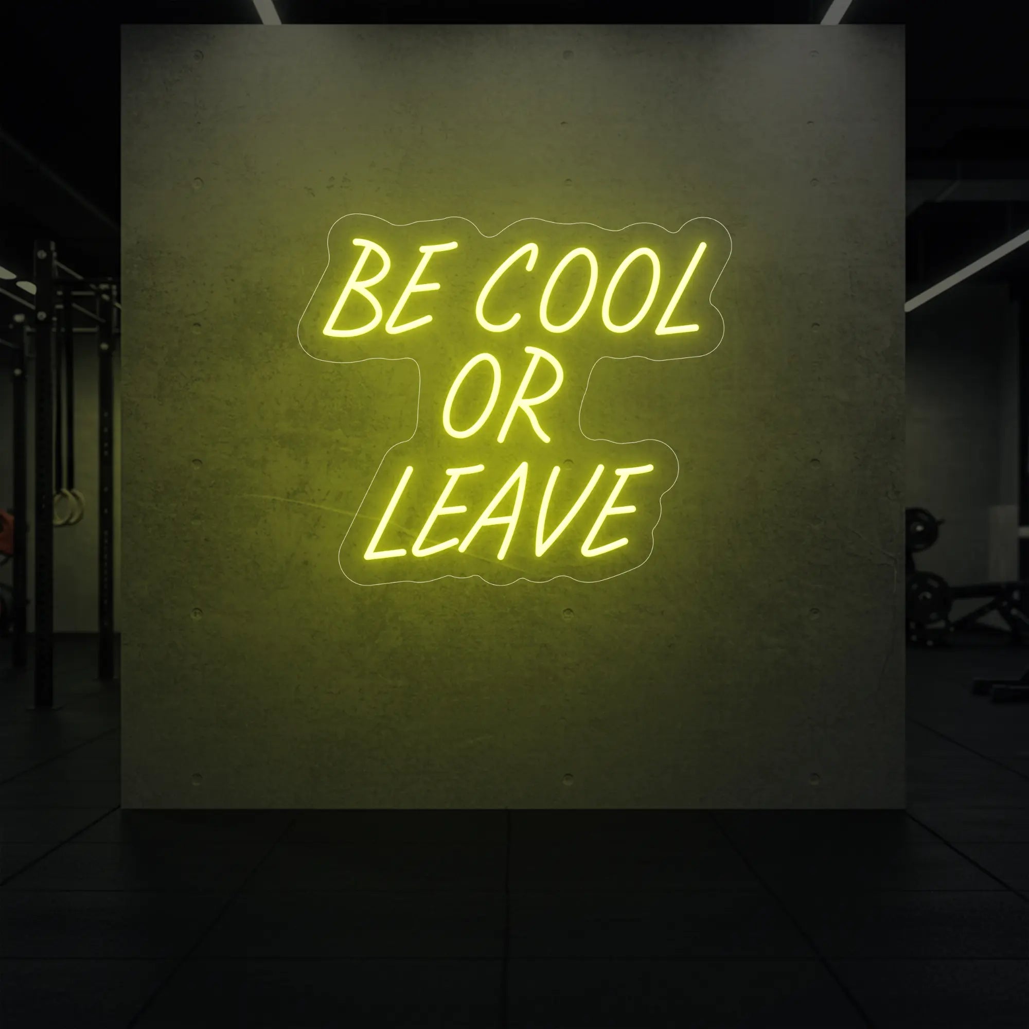 'Be Cool or Leave' neon sign glowing in lemon yellow against a styled interior wall.