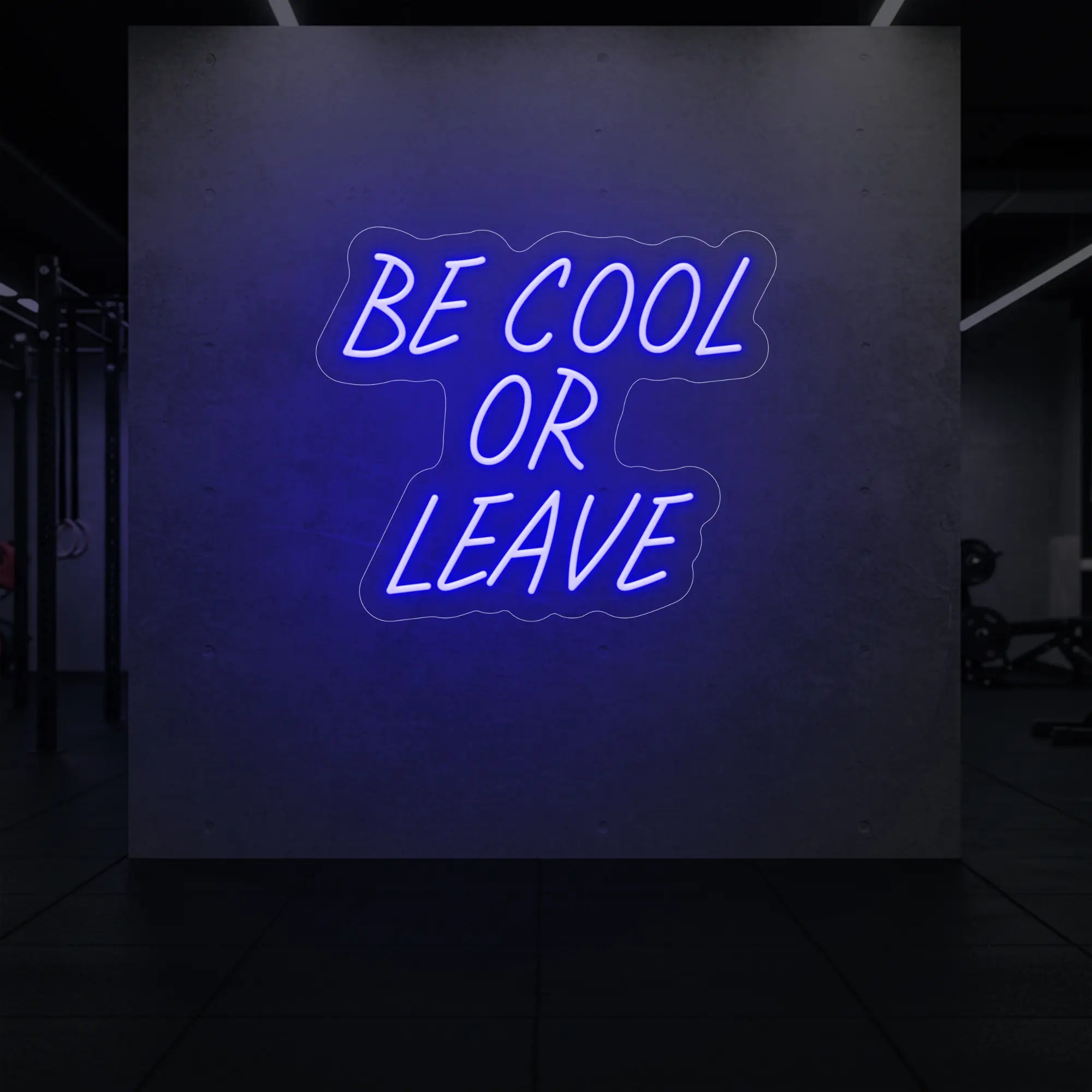 'Be Cool or Leave' neon sign glowing in deep blue against a styled interior wall.