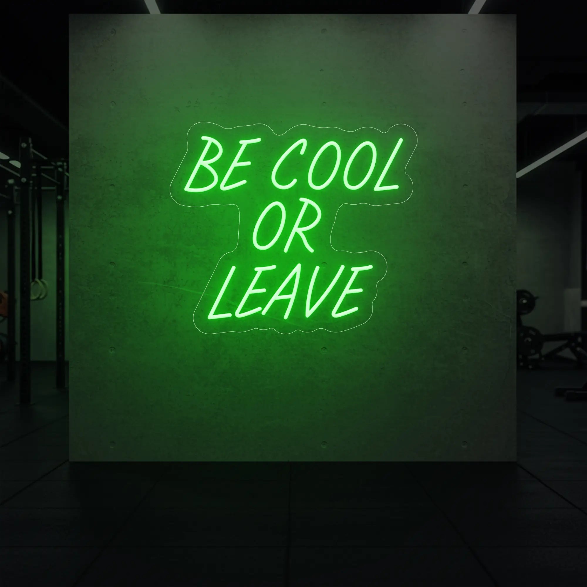 'Be Cool or Leave' neon sign glowing in green against a styled interior wall.