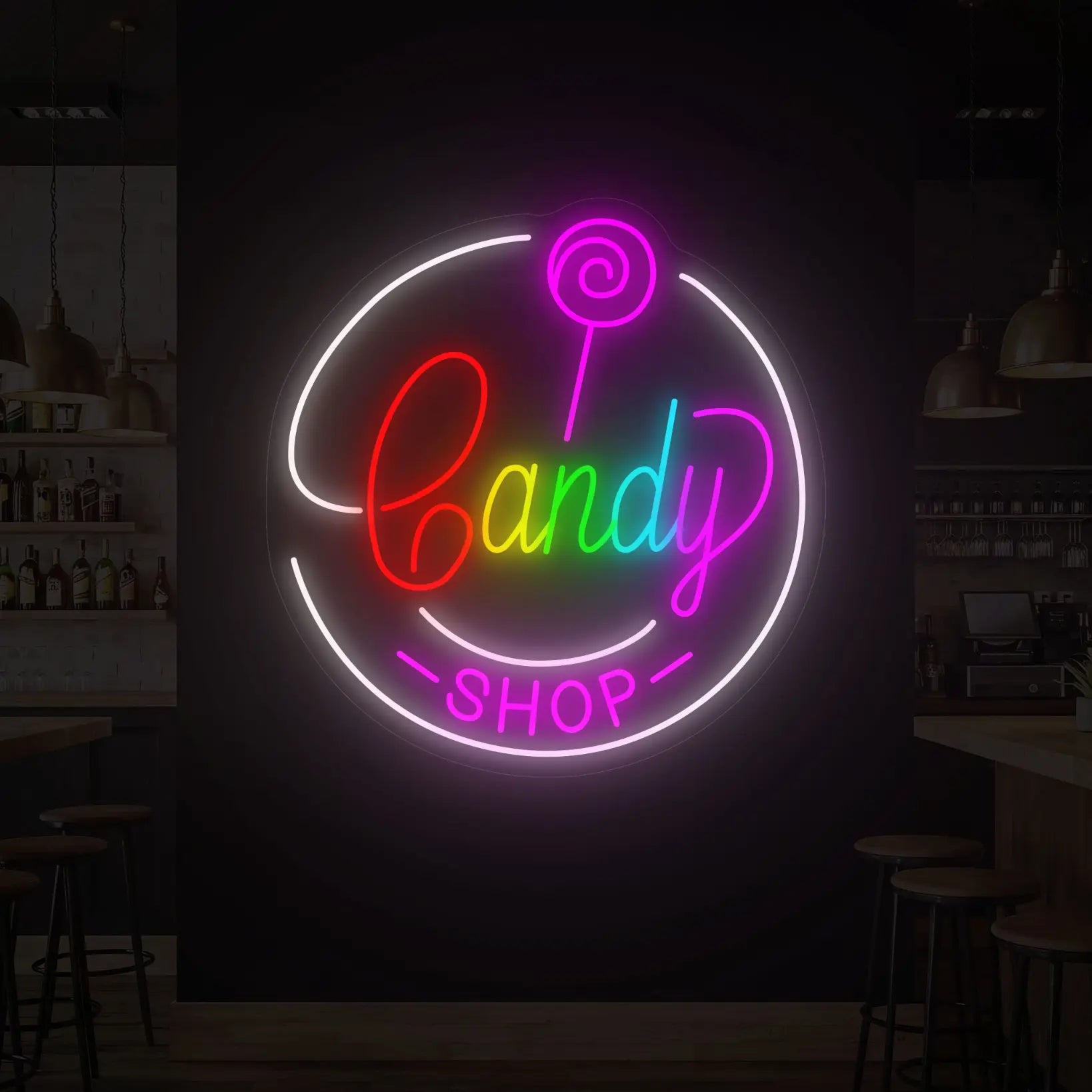 Photo of the 'CANDY SHOP' neon sign glowing in multi-color against a styled interior wall.