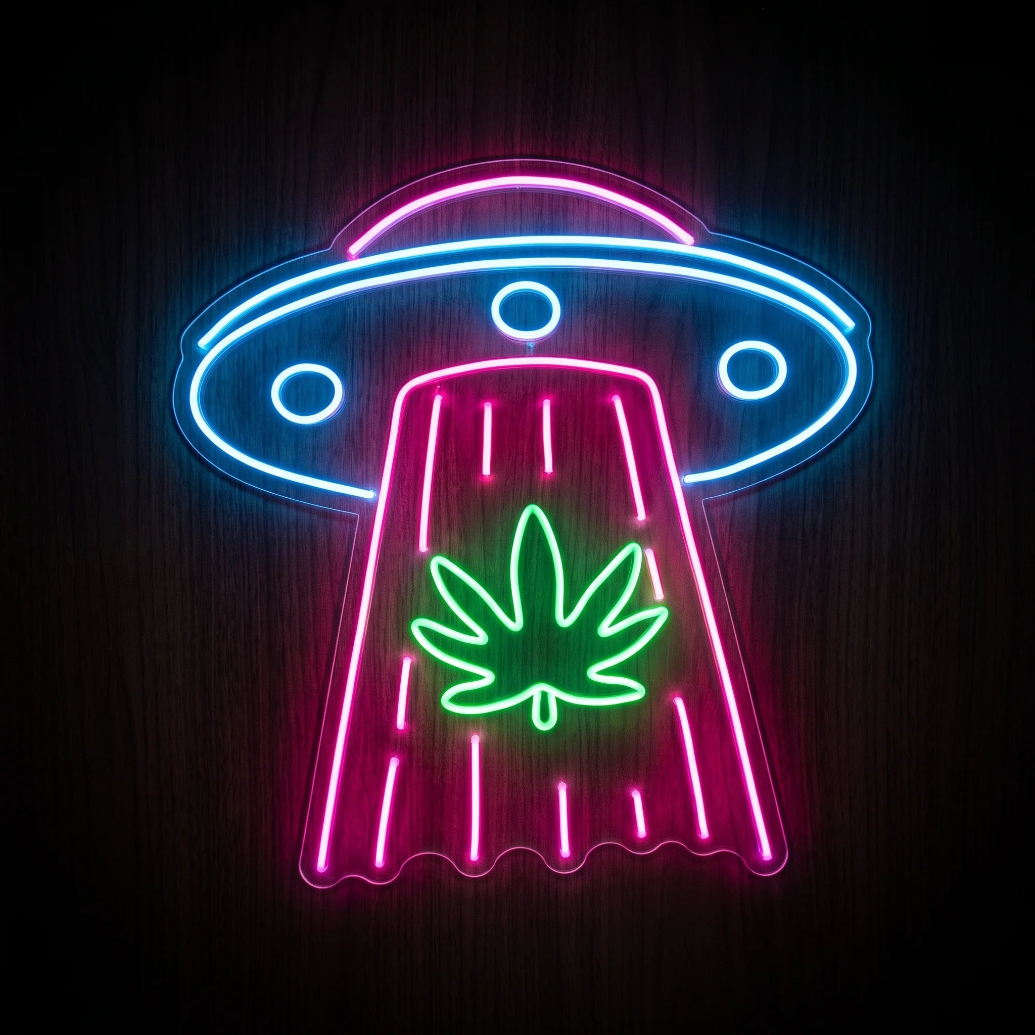Blue and pink UFO LED neon sign abducting a green cannabis leaf on clear acrylic backing for dispensary and recreational wall décor.
