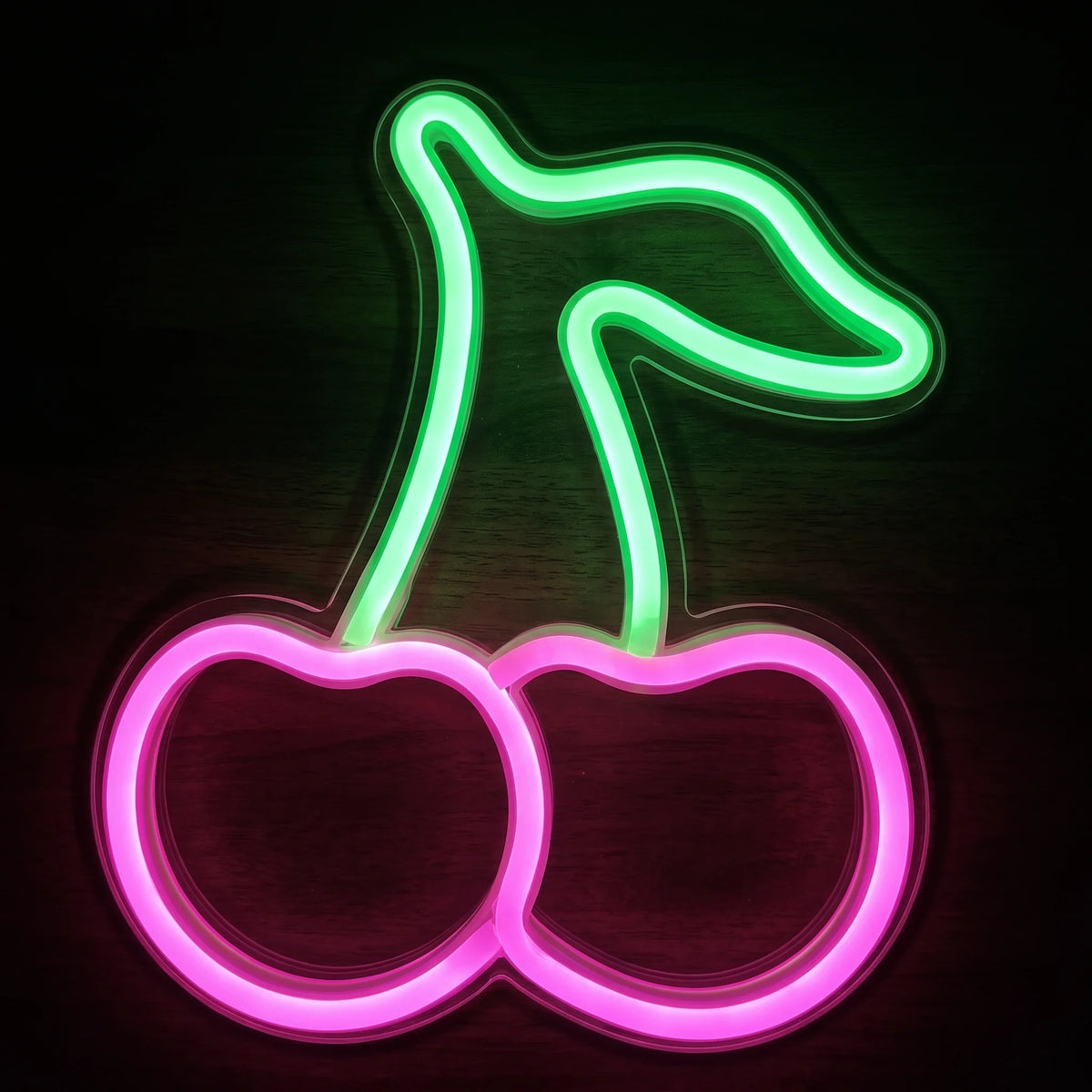 Pink cherries LED neon sign with green stem and leaf on clear acrylic backing.