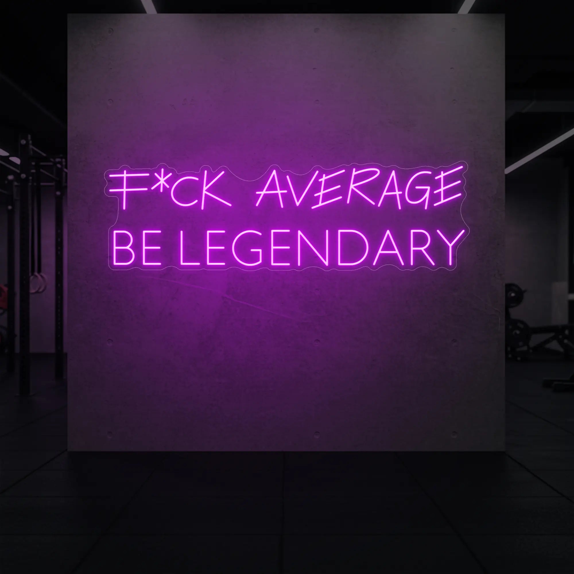 'F*ck Average Be Legendary' neon sign glowing in deep pink against a styled interior wall.