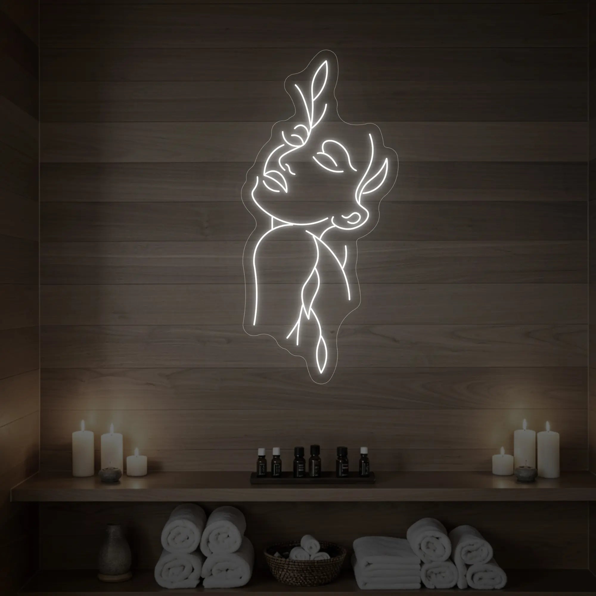 Photo of the 'Flower Girl' neon sign featuring a minimalist face and leaf line art glowing in cool white against a styled interior wall.