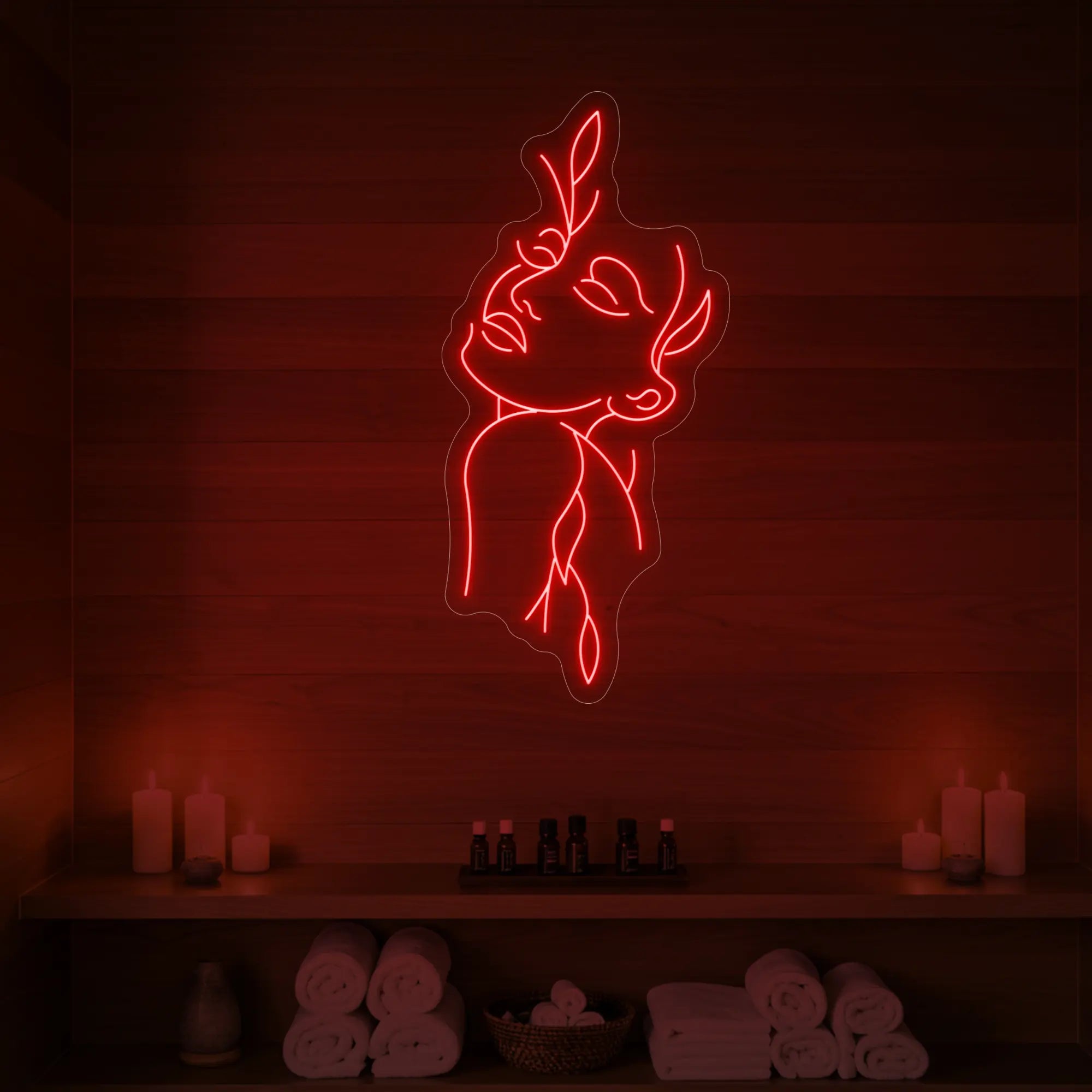 Photo of the 'Flower Girl' neon sign featuring a minimalist face and leaf line art glowing in red against a styled interior wall.