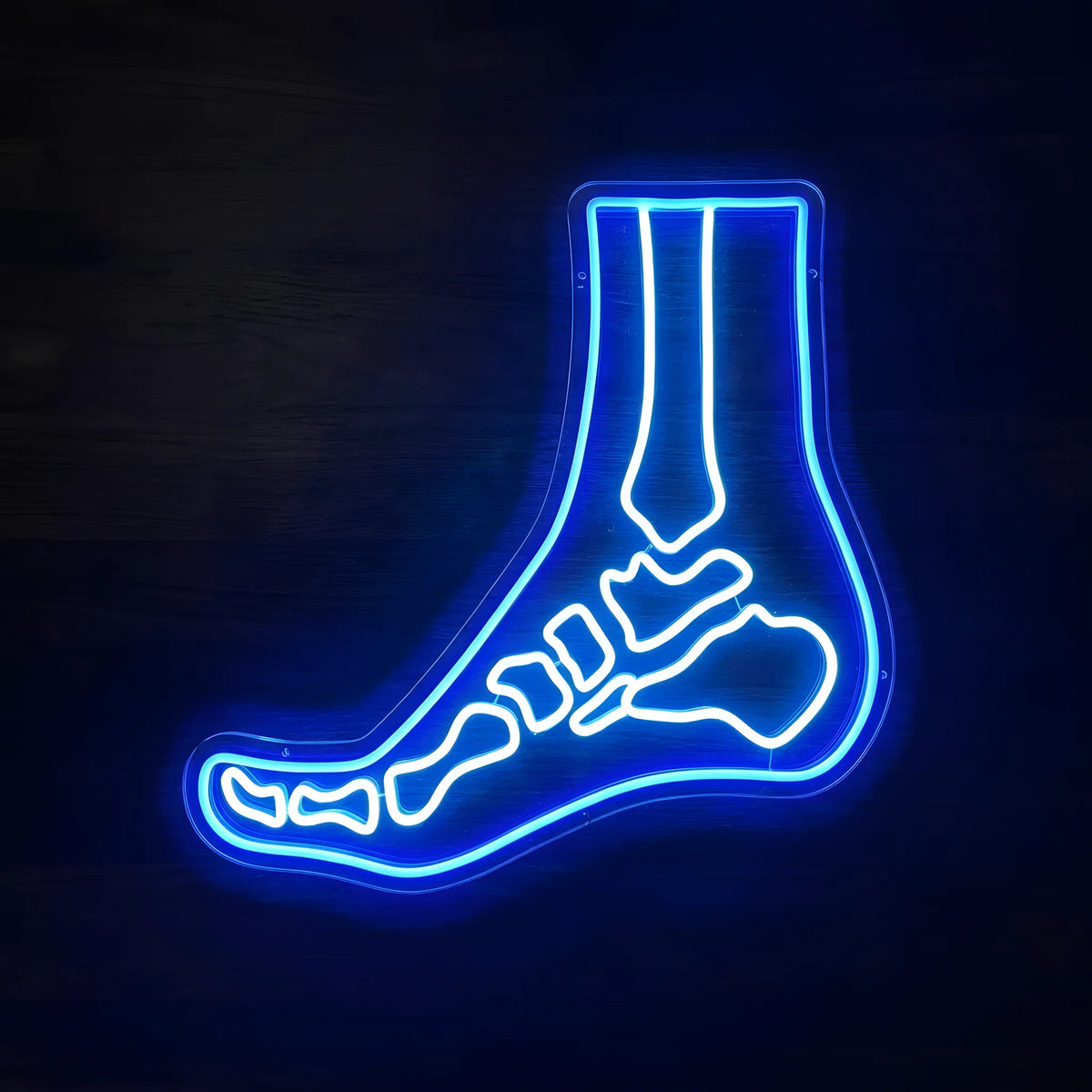 Foot and Ankle Chiropractic LED neon sign featuring an anatomical side-view foot illustration with blue outer outline and cool white skeletal details on clear acrylic backing for podiatry and chiropractic clinic decor.