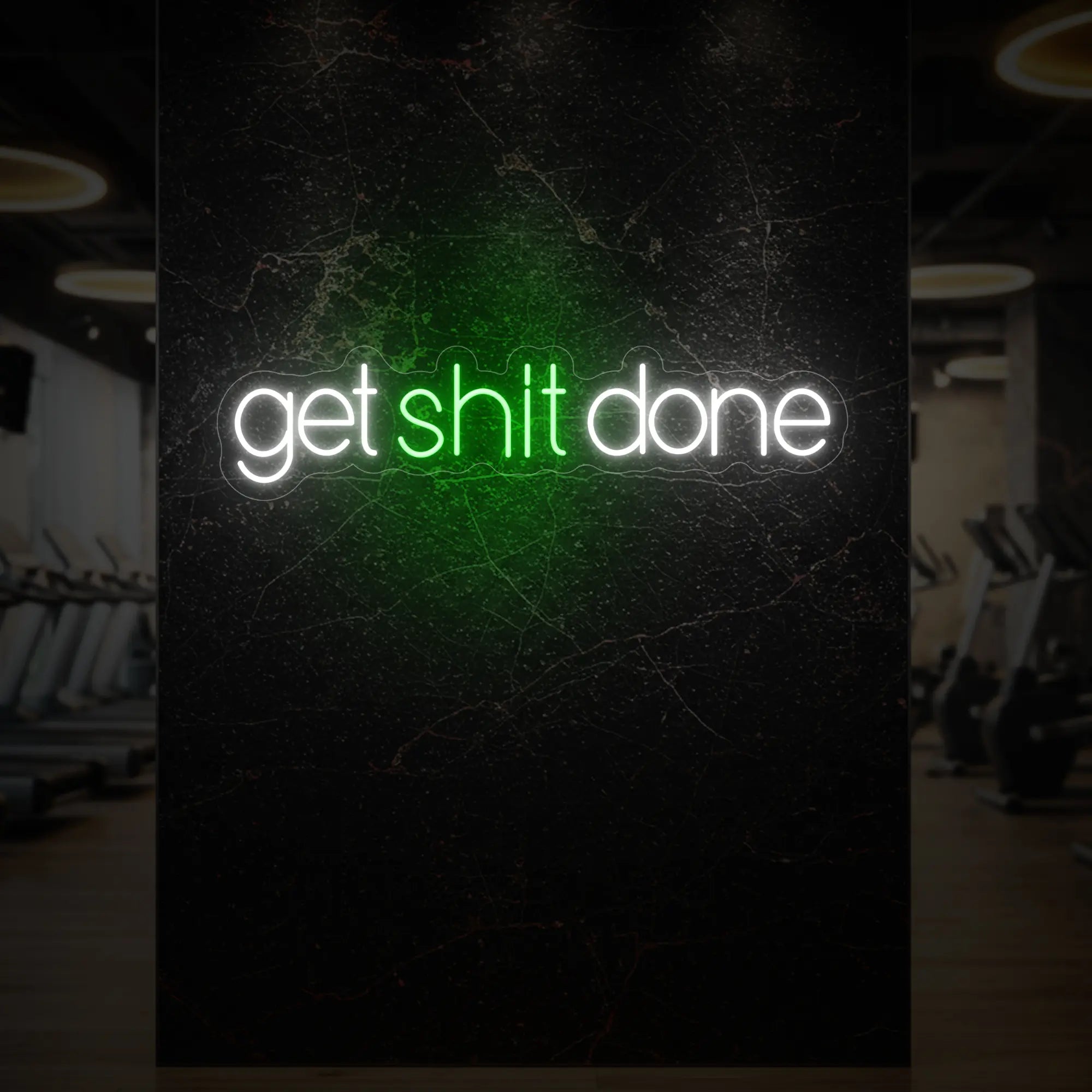 'Get Shit Done' neon sign glowing in green against a styled interior wall.