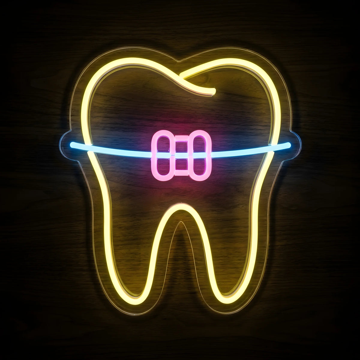 Golden Braces Tooth LED neon sign featuring a golden-yellow tooth outline, pink orthodontic bracket, and blue archwire on clear acrylic backing for orthodontic and dental clinic wall decor.