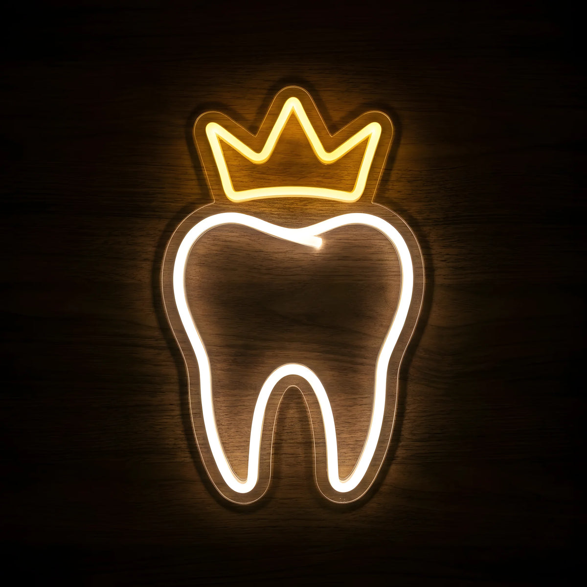 Golden Crown Dental Tooth LED neon sign featuring a glowing warm white tooth outline topped with a golden-yellow crown on clear acrylic backing against a dark wooden wall.