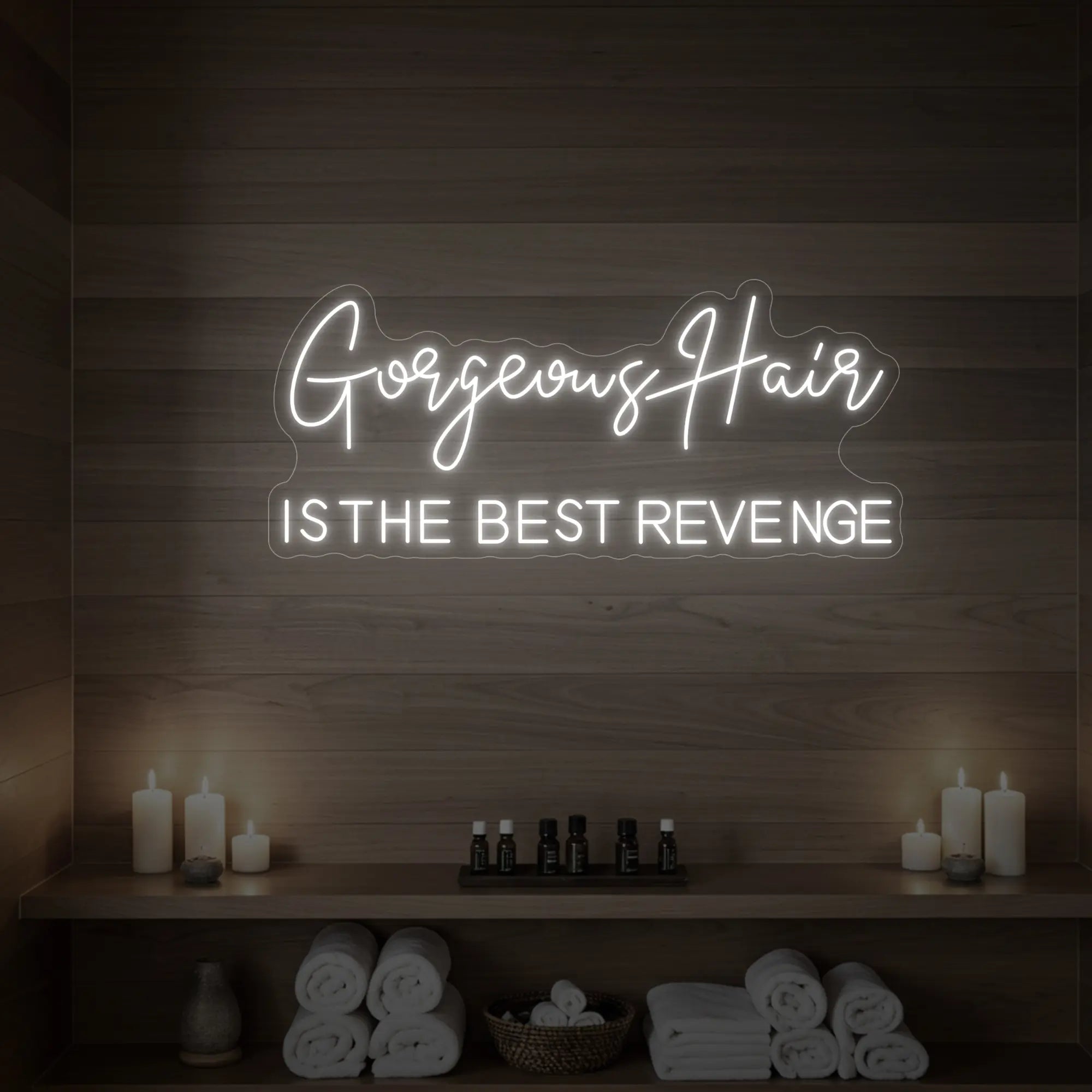 Photo of the 'Gorgeous Hair is the Best Revenge' neon sign glowing in cool white against a styled interior wall.