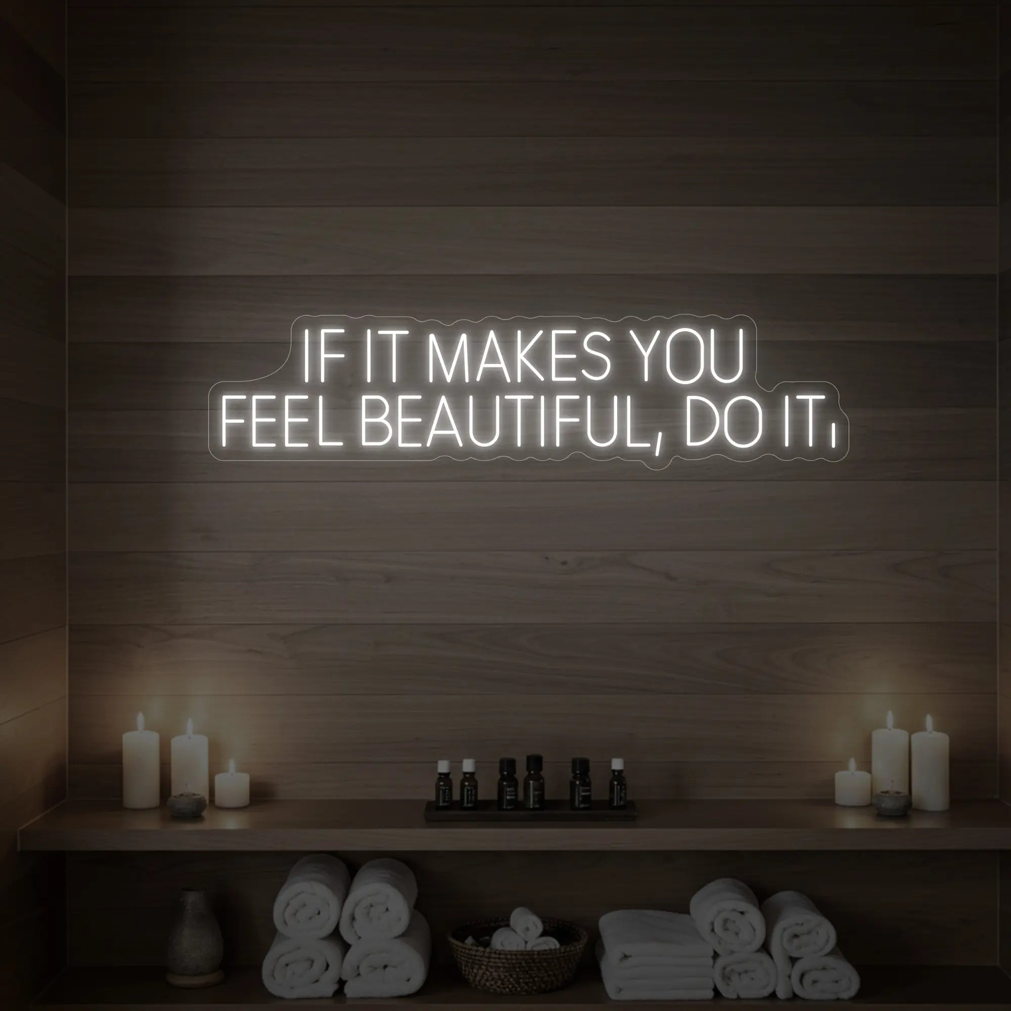 Photo of the 'IF IT MAKES YOU FEEL BEAUTIFUL, DO IT.' neon sign glowing in cool white against a styled interior wall.