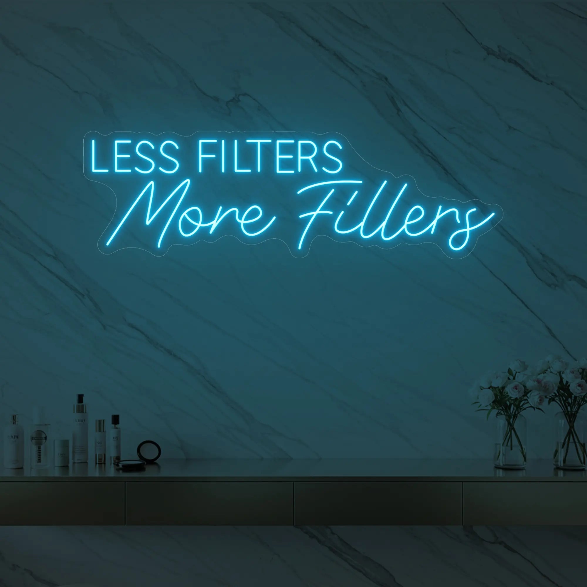 Photo of the 'LESS FILTERS MORE FILLERS' neon sign glowing in ice blue against a marble wall.