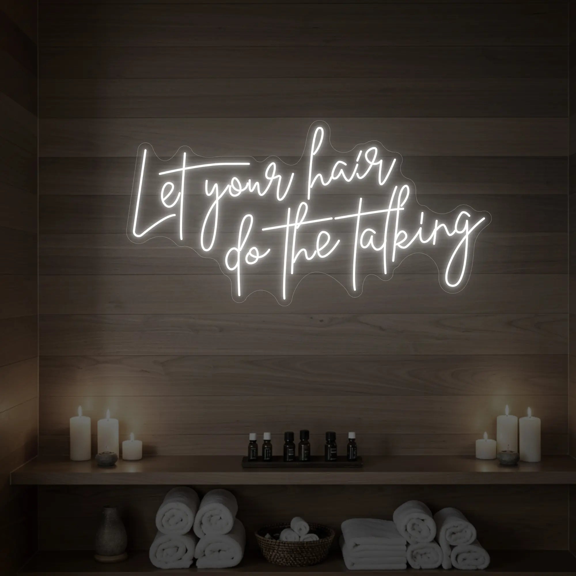Photo of the 'Let your hair do the talking' neon sign glowing in cool white against a wooden wall.