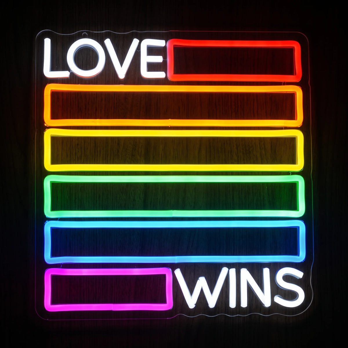 Love Wins Pride LED Neon Sign featuring white LOVE WINS lettering with colorful red, orange, yellow, green, blue and pink-purple illuminated bars.