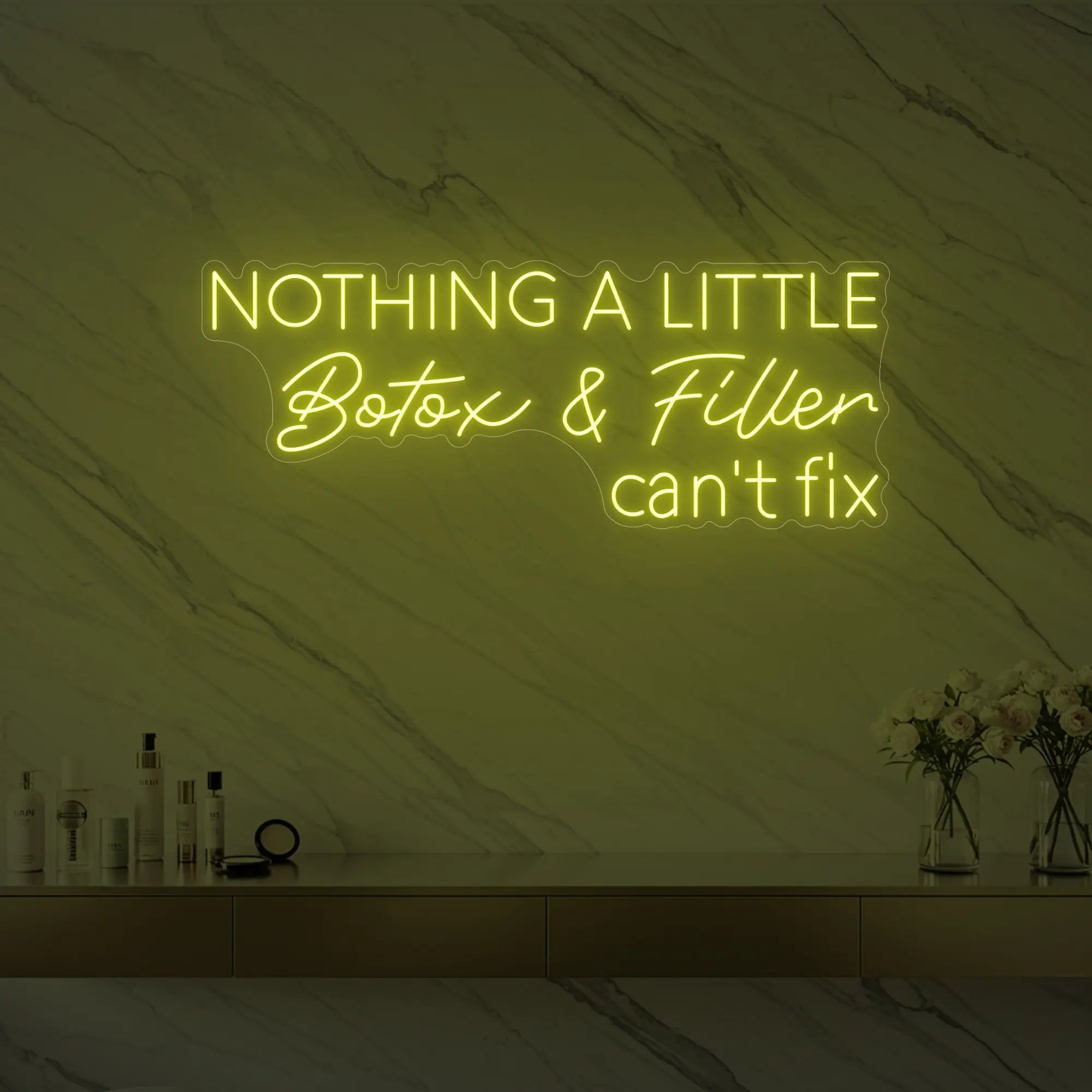 Photo of the 'Nothing a Little Botox & Filler Can’t Fix' neon sign glowing in lemon yellow against a styled interior wall.