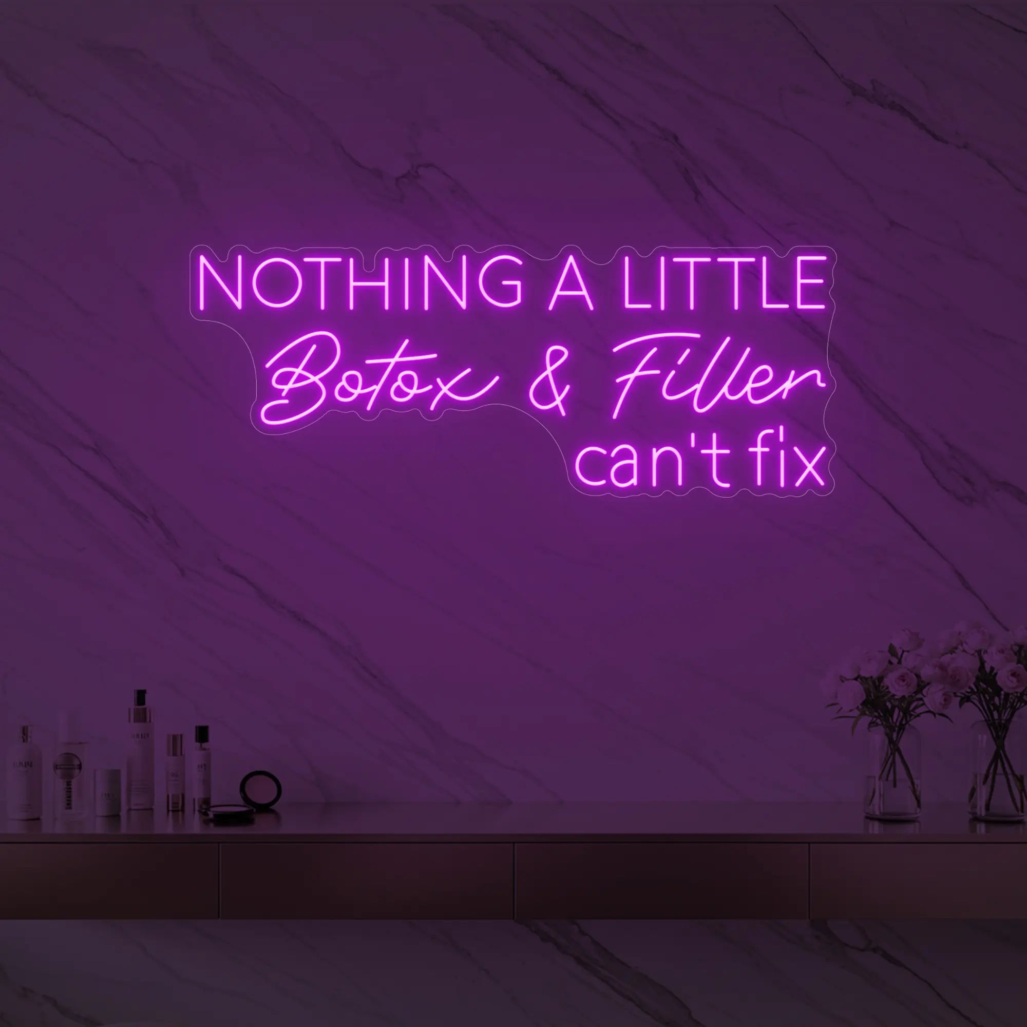 Photo of the 'Nothing a Little Botox & Filler Can’t Fix' neon sign glowing in deep pink against a styled interior wall.