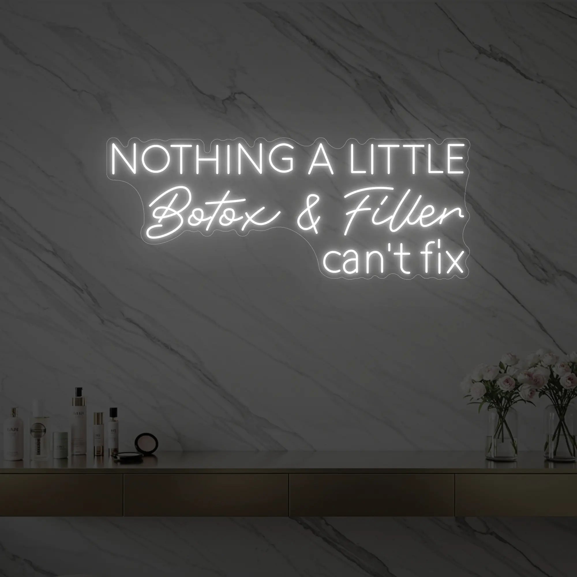 Photo of the 'Nothing a Little Botox & Filler Can’t Fix' neon sign glowing in cool white against a styled interior wall.