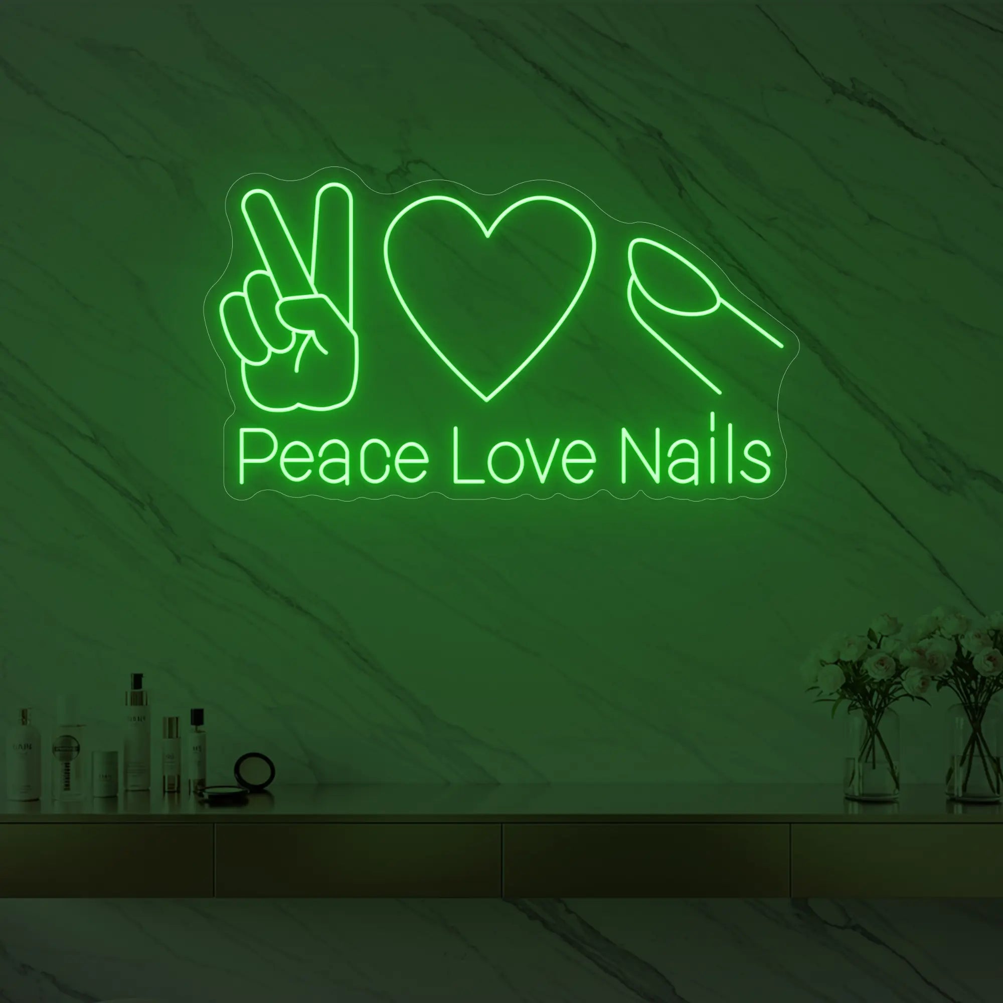 Photo of the 'Peace Love Nails' neon sign glowing in green against a styled interior wall.