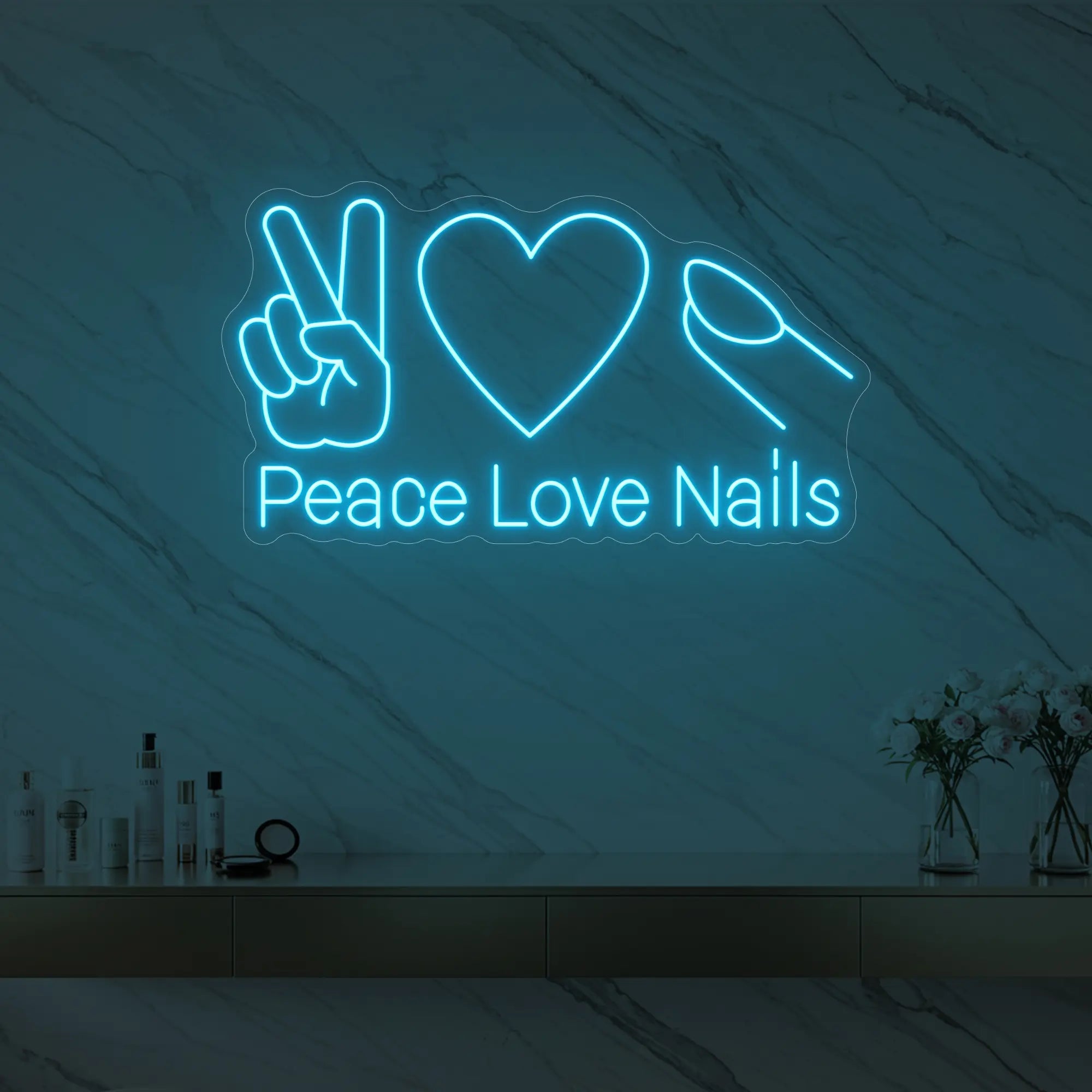 Photo of the 'Peace Love Nails' neon sign glowing in ice blue against a styled interior wall.