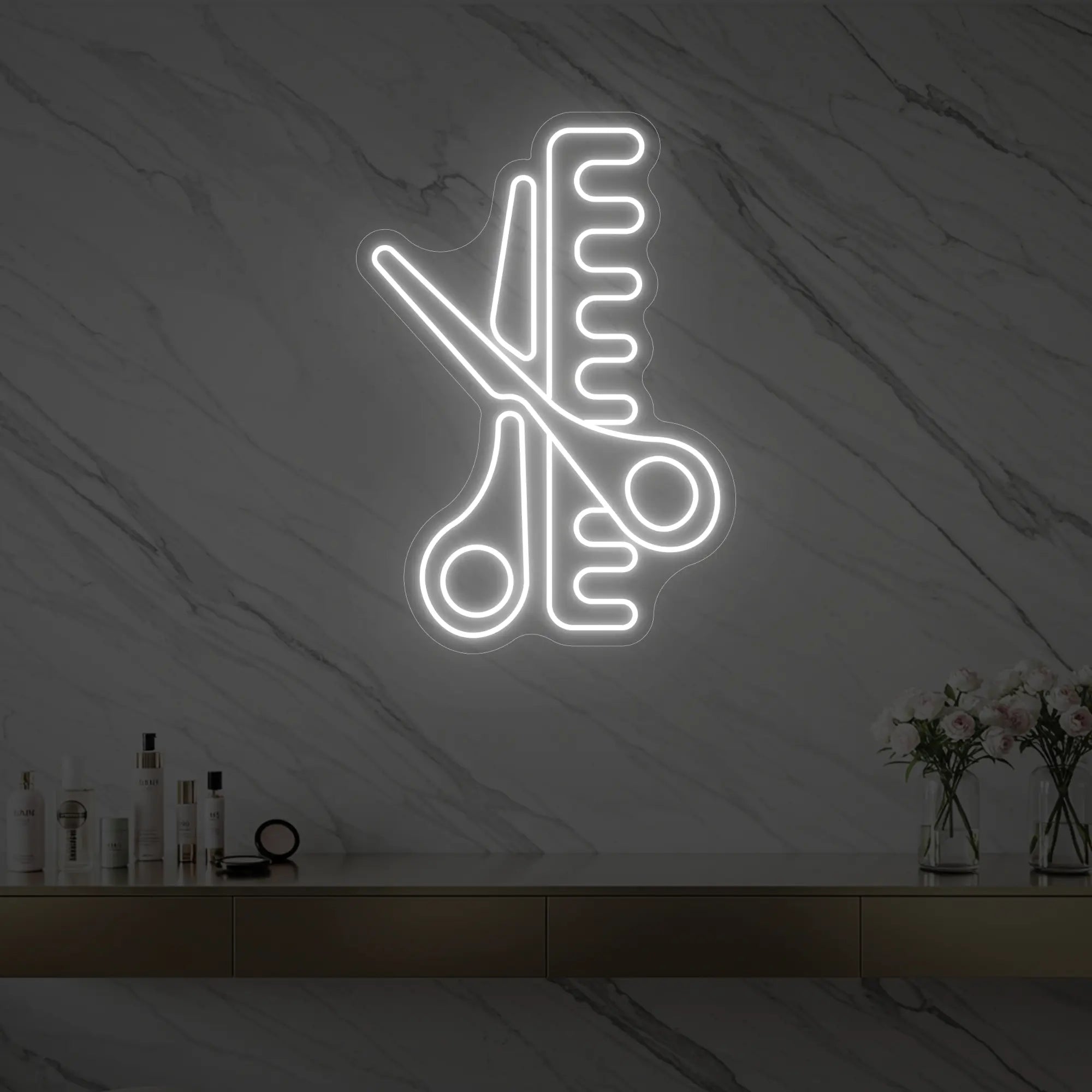 Photo of the 'Scissors and Comb' neon sign glowing in cool white against a styled interior wall.