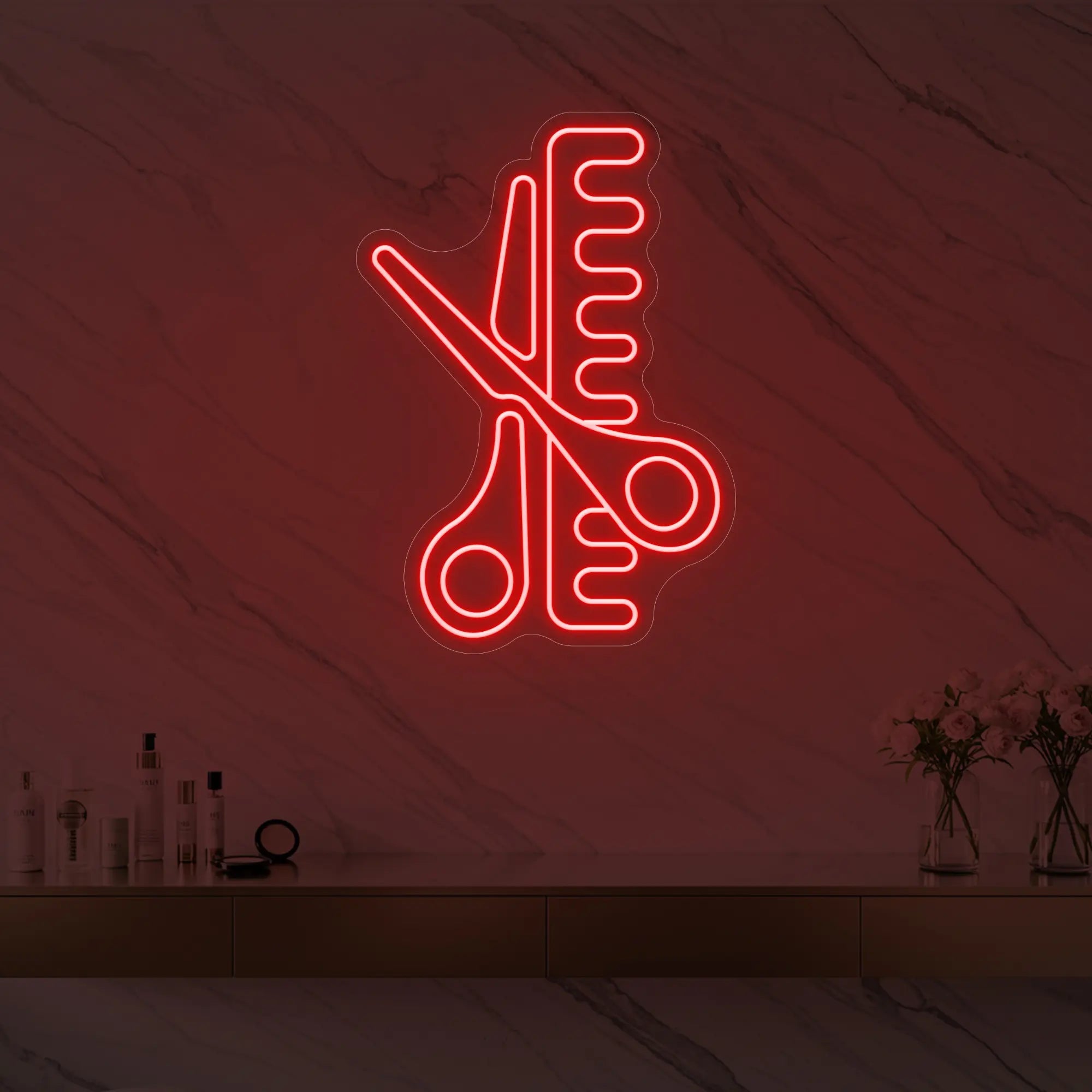Photo of the 'Scissors and Comb' neon sign glowing in red against a styled interior wall.