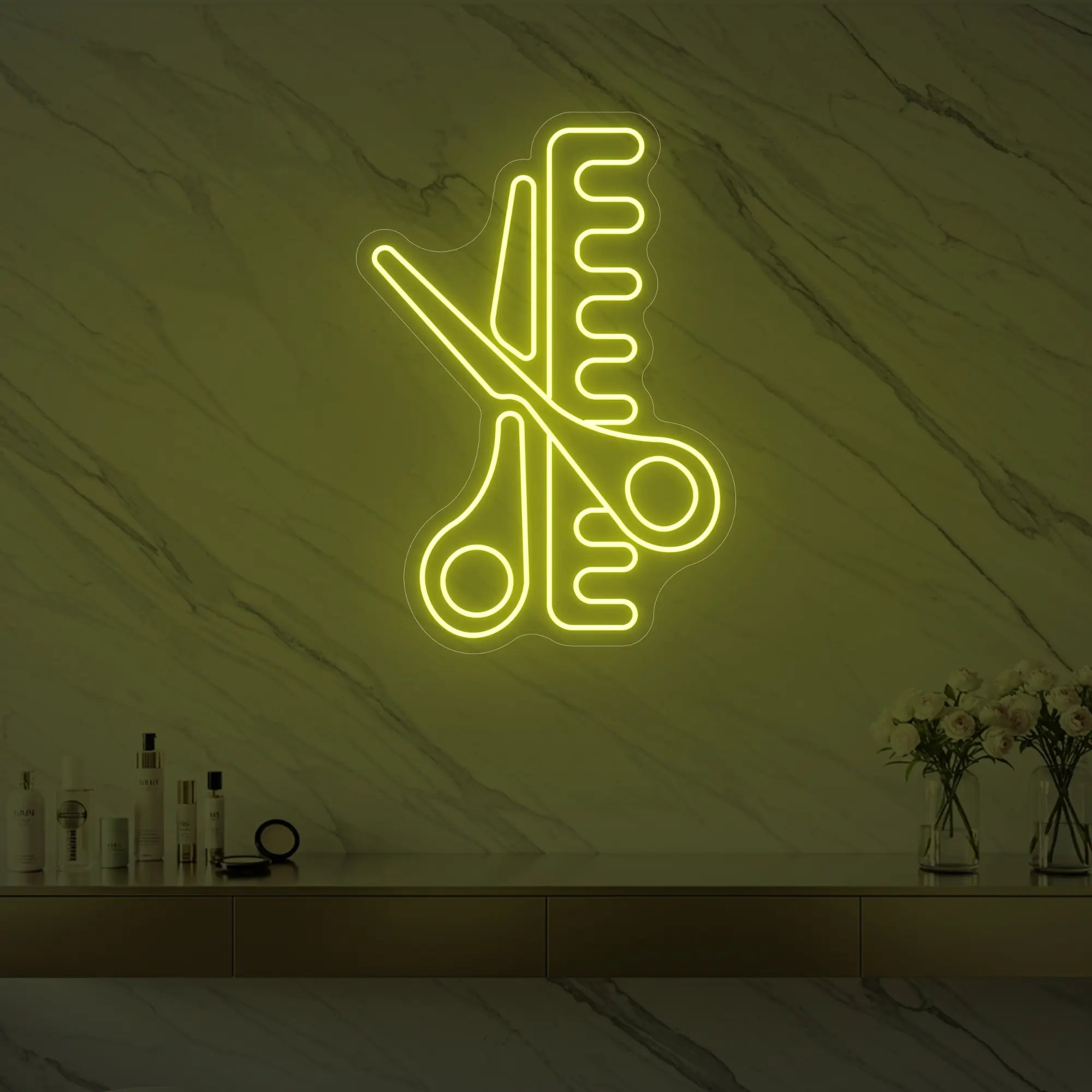 Photo of the 'Scissors and Comb' neon sign glowing in lemon yellow against a styled interior wall.