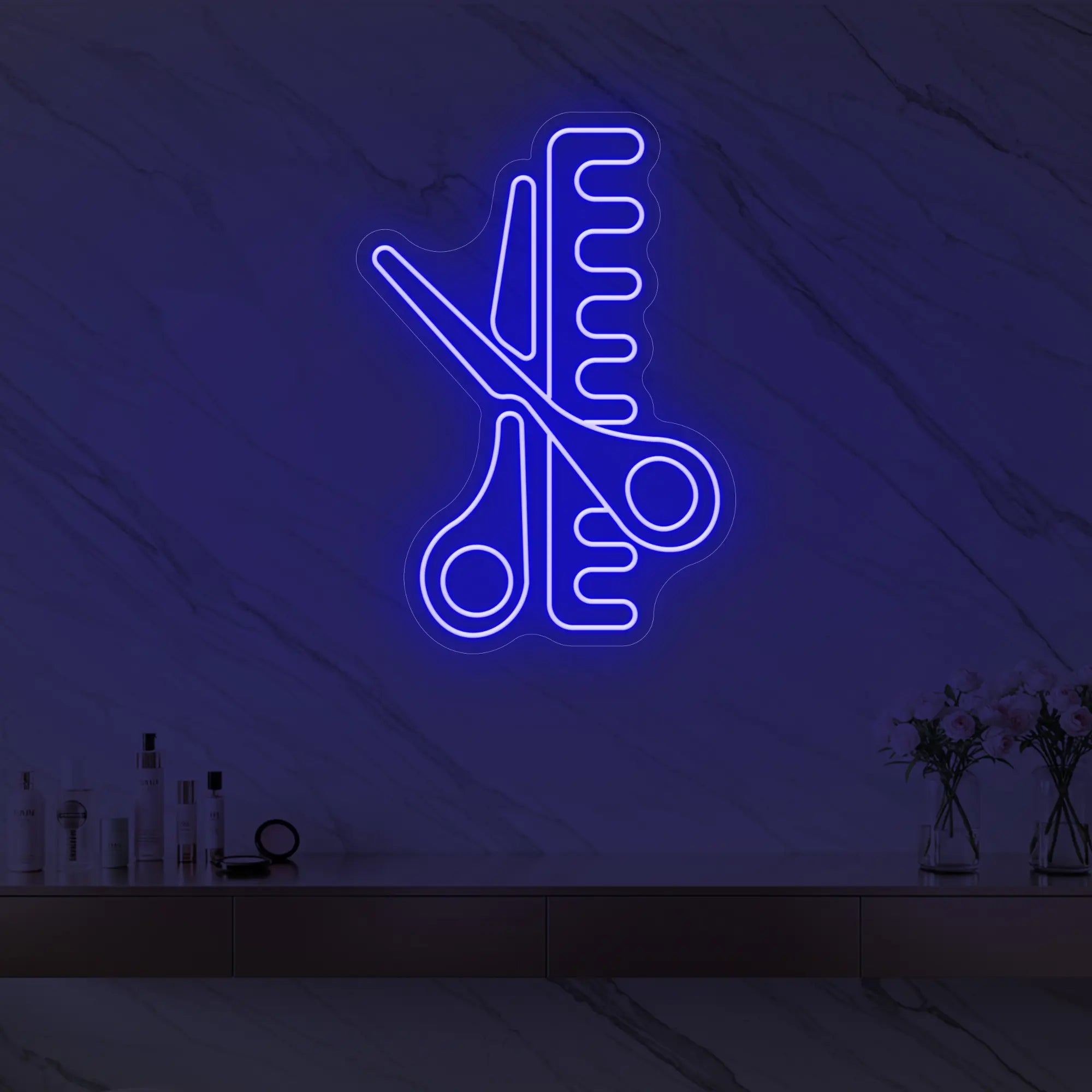 Photo of the 'Scissors and Comb' neon sign glowing in deep blue against a styled interior wall.