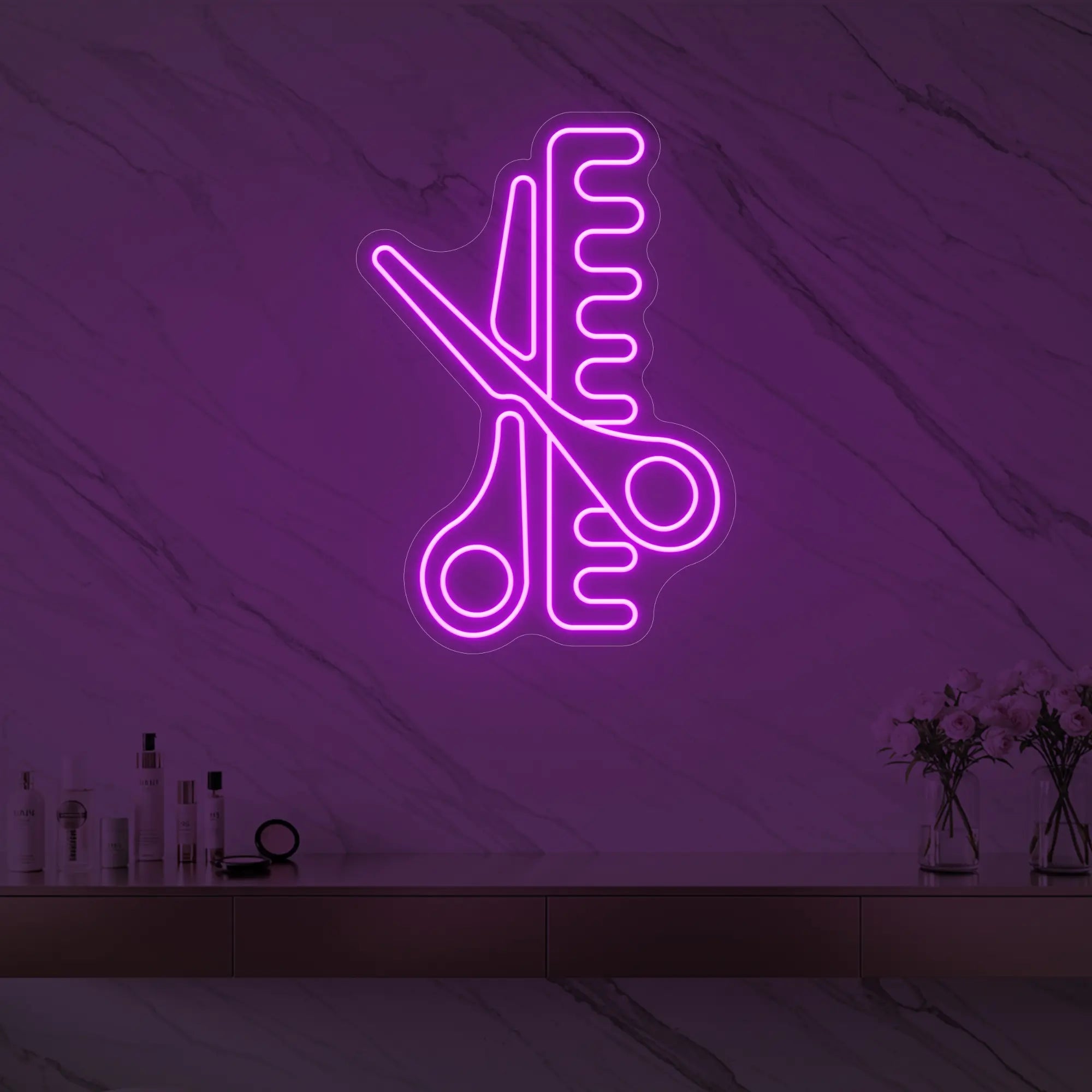 Photo of the 'Scissors and Comb' neon sign glowing in deep pink against a styled interior wall.