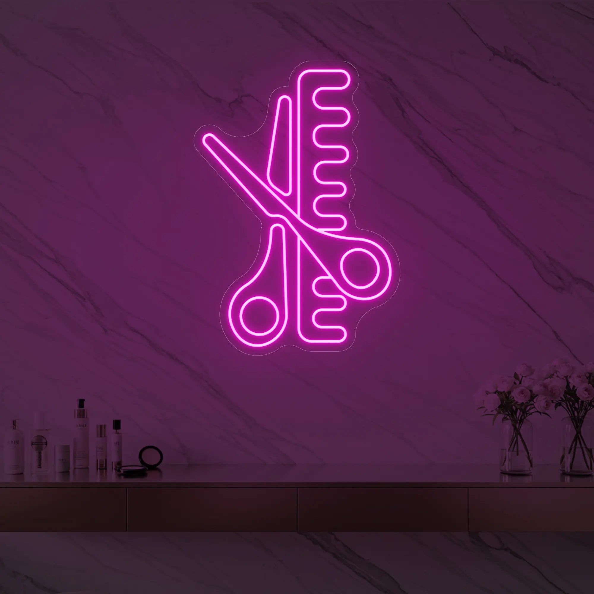 Photo of the 'Scissors and Comb' neon sign glowing in light pink against a styled interior wall.