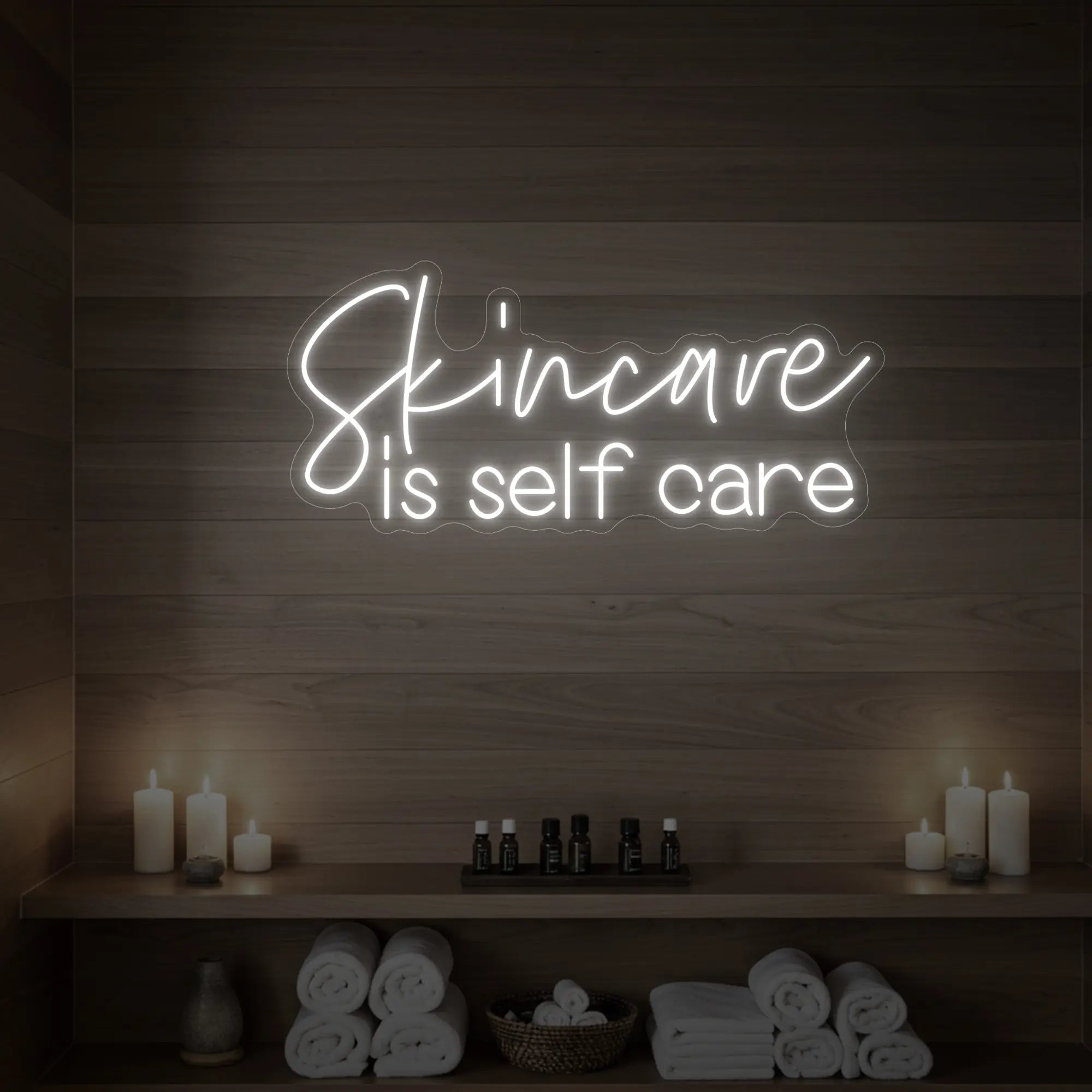 Photo of the 'Skincare is Self Care' neon sign glowing in cool white against a styled interior wall.