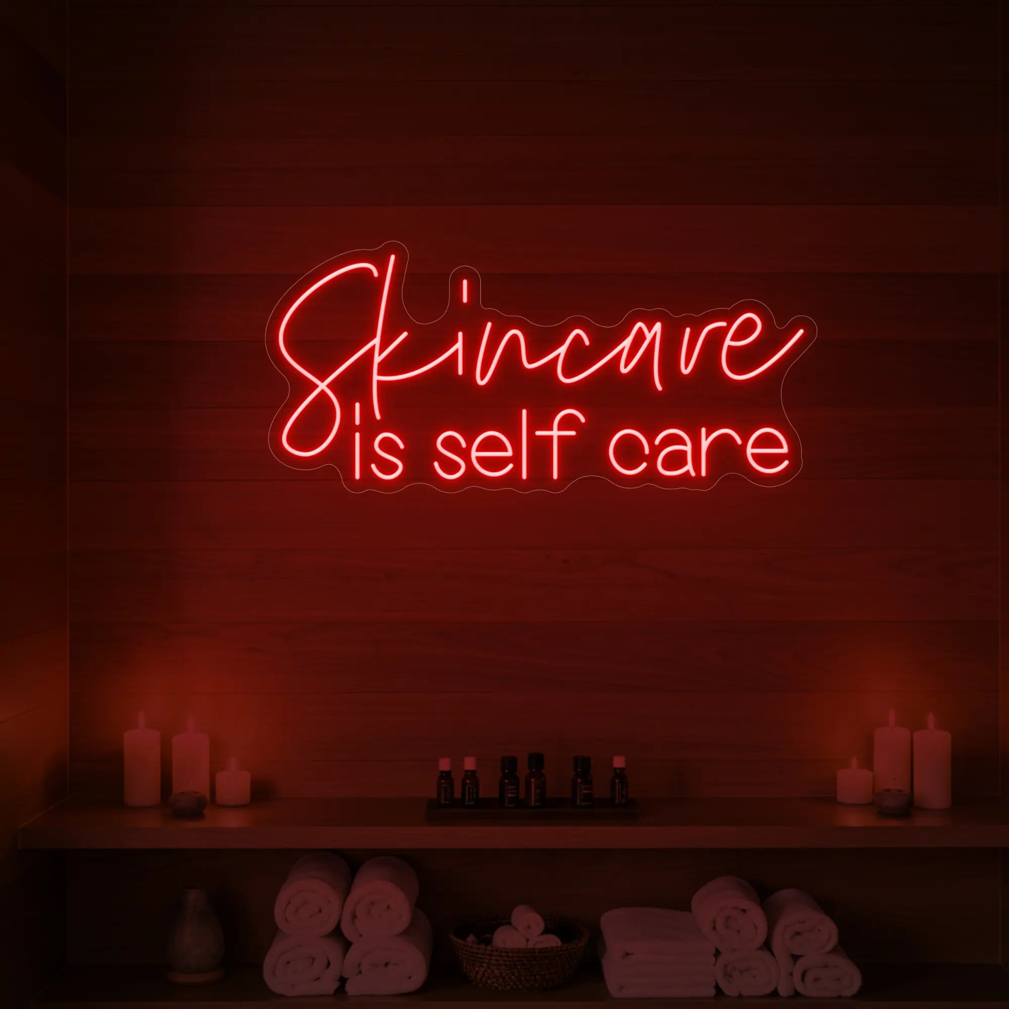 Photo of the 'Skincare is Self Care' neon sign glowing in red against a styled interior wall.