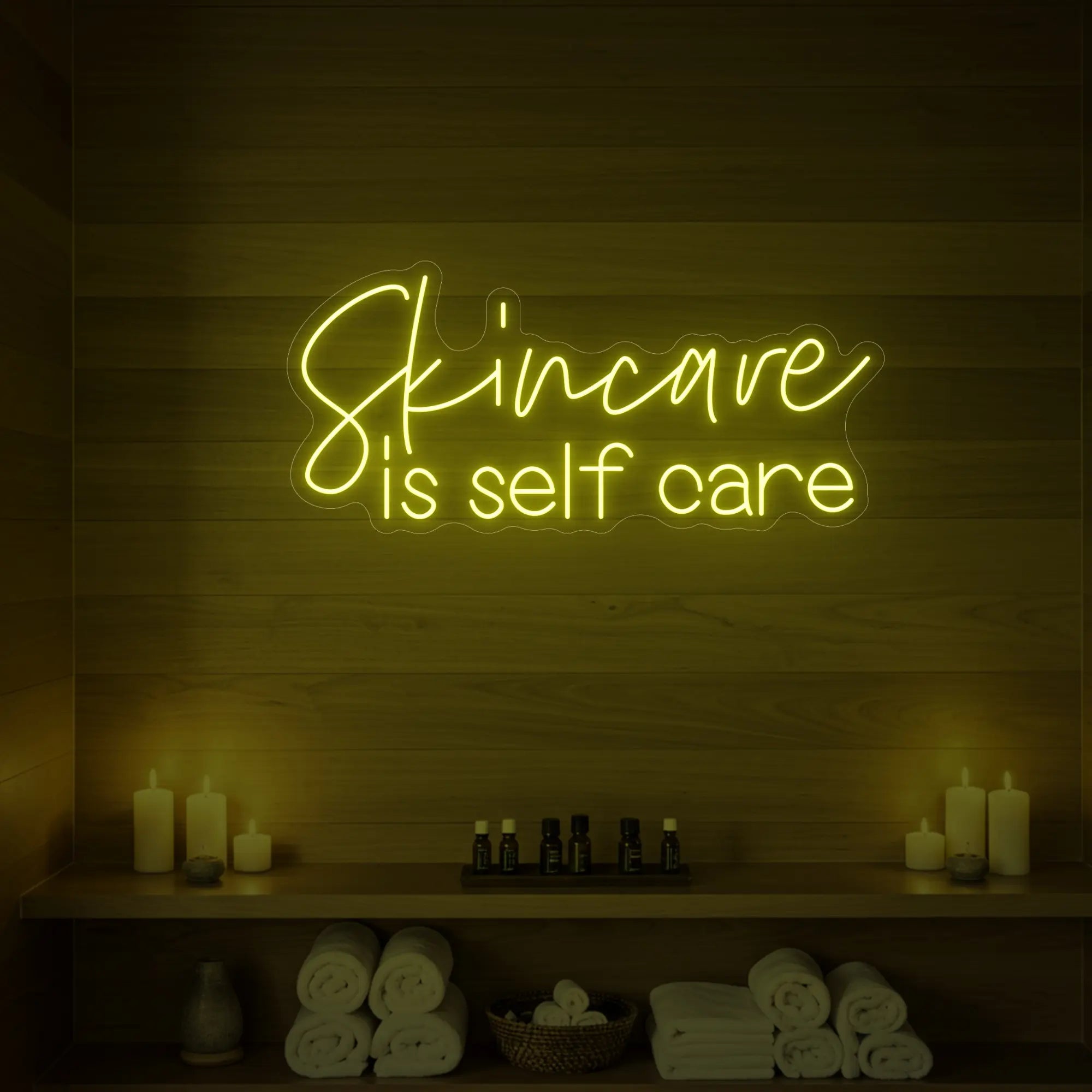 Photo of the 'Skincare is Self Care' neon sign glowing in lemon yellow against a styled interior wall.