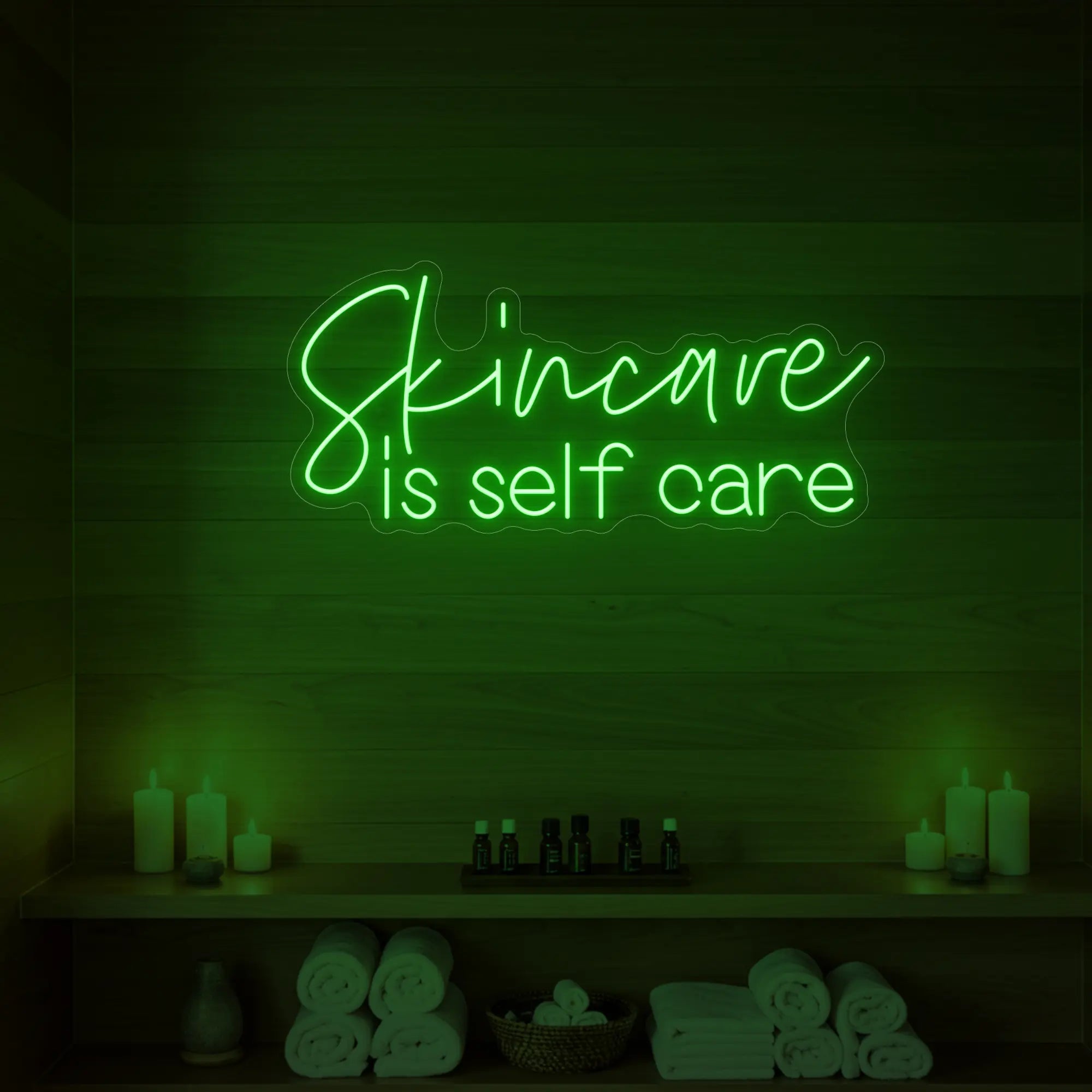 Photo of the 'Skincare is Self Care' neon sign glowing in green against a styled interior wall.