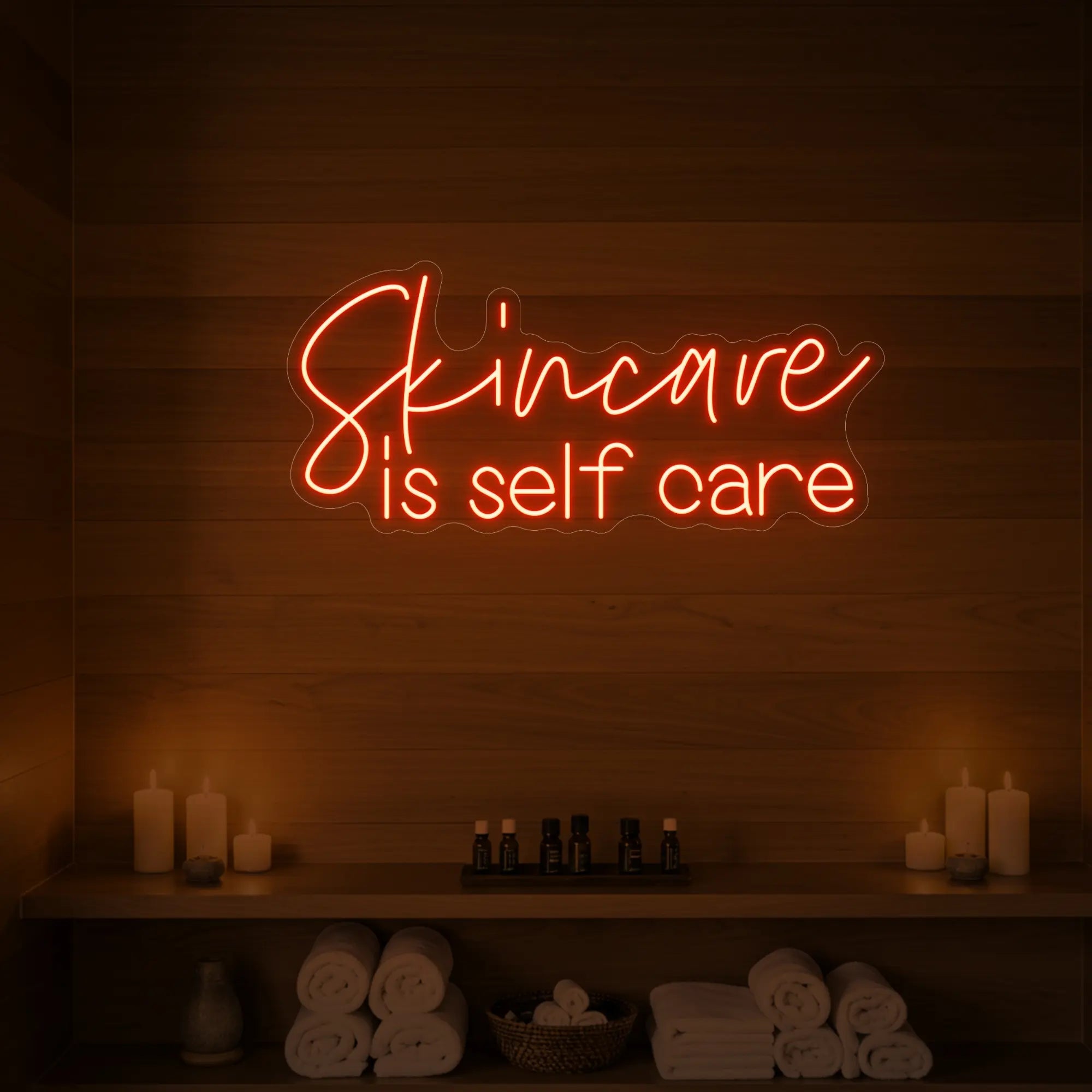 Photo of the 'Skincare is Self Care' neon sign glowing in golden yellow against a styled interior wall.