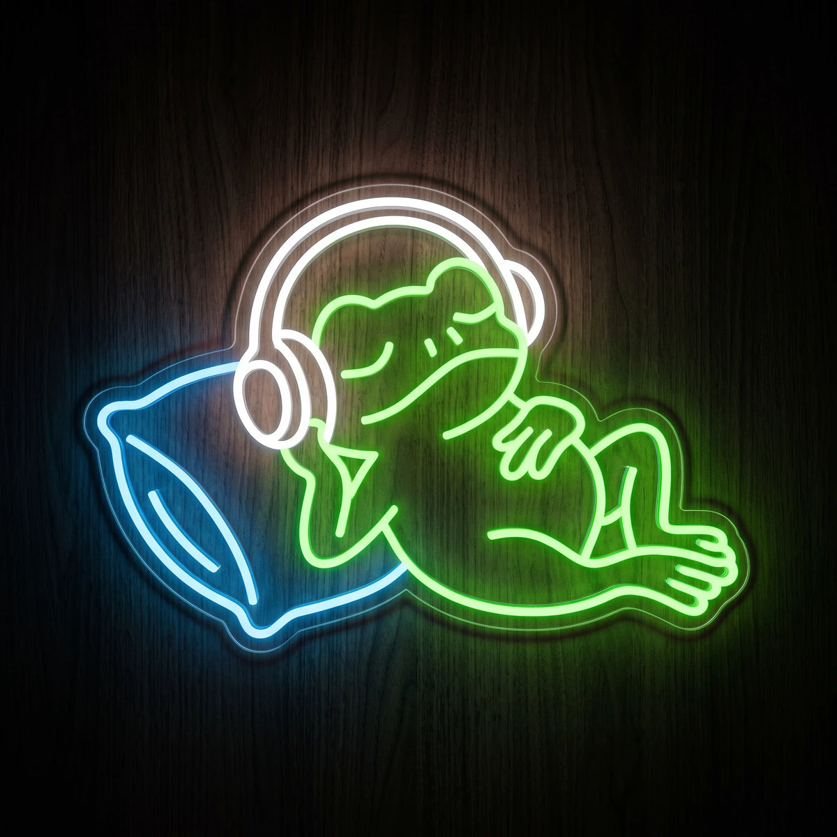 Sleeping Frog LED Neon Sign featuring a green lounging frog wearing white headphones and resting on a blue pillow.