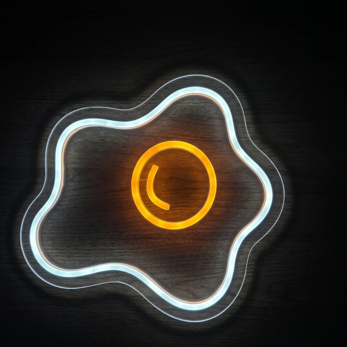 Sunny Side Up Egg LED neon sign with bright white fried egg outline and glowing yellow-orange yolk on clear acrylic backing.