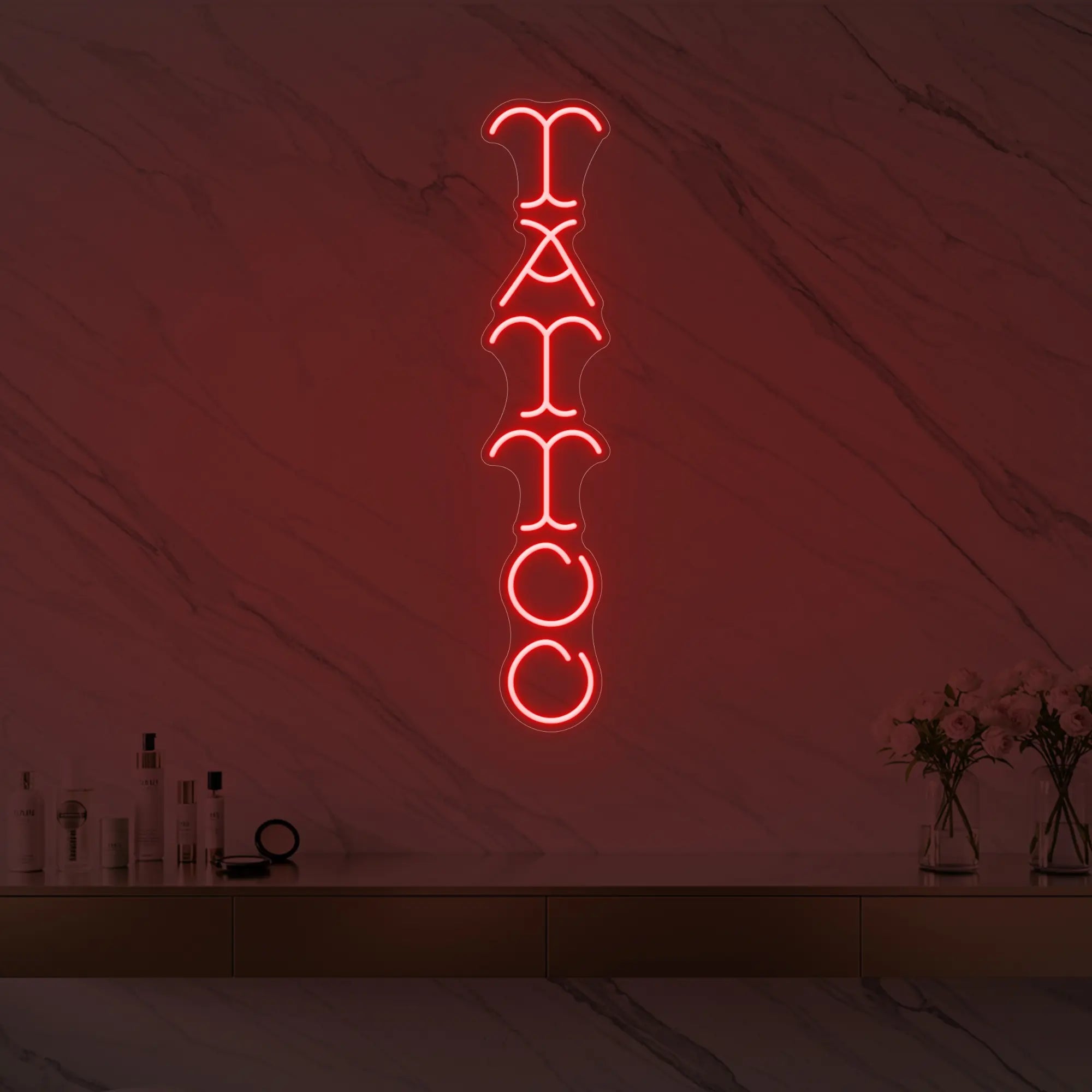 Photo of the 'Vertical Tattoo' neon sign glowing in red against a styled interior wall.