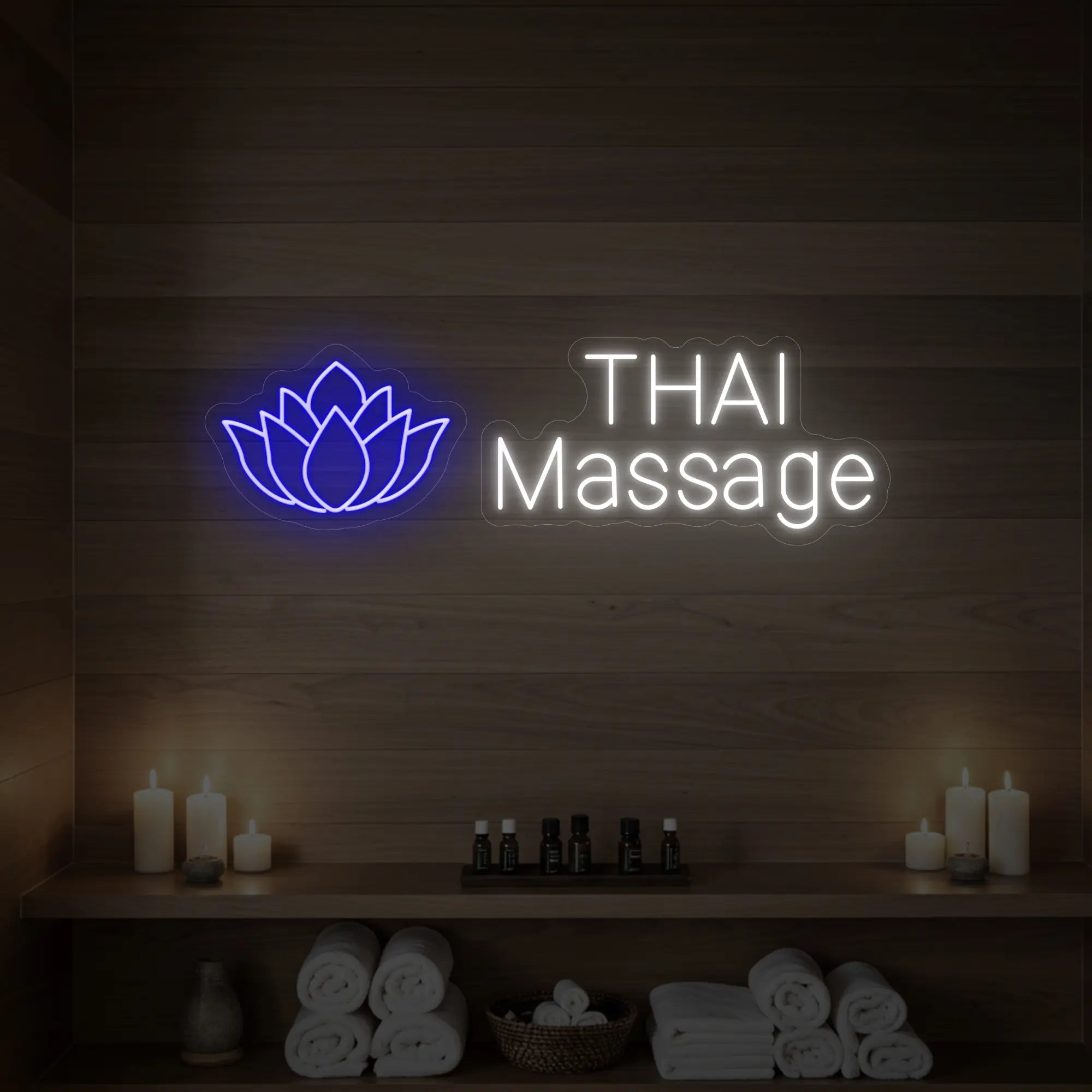 Photo of the 'Thai Massage' neon sign glowing in deep blue against a styled interior wall.