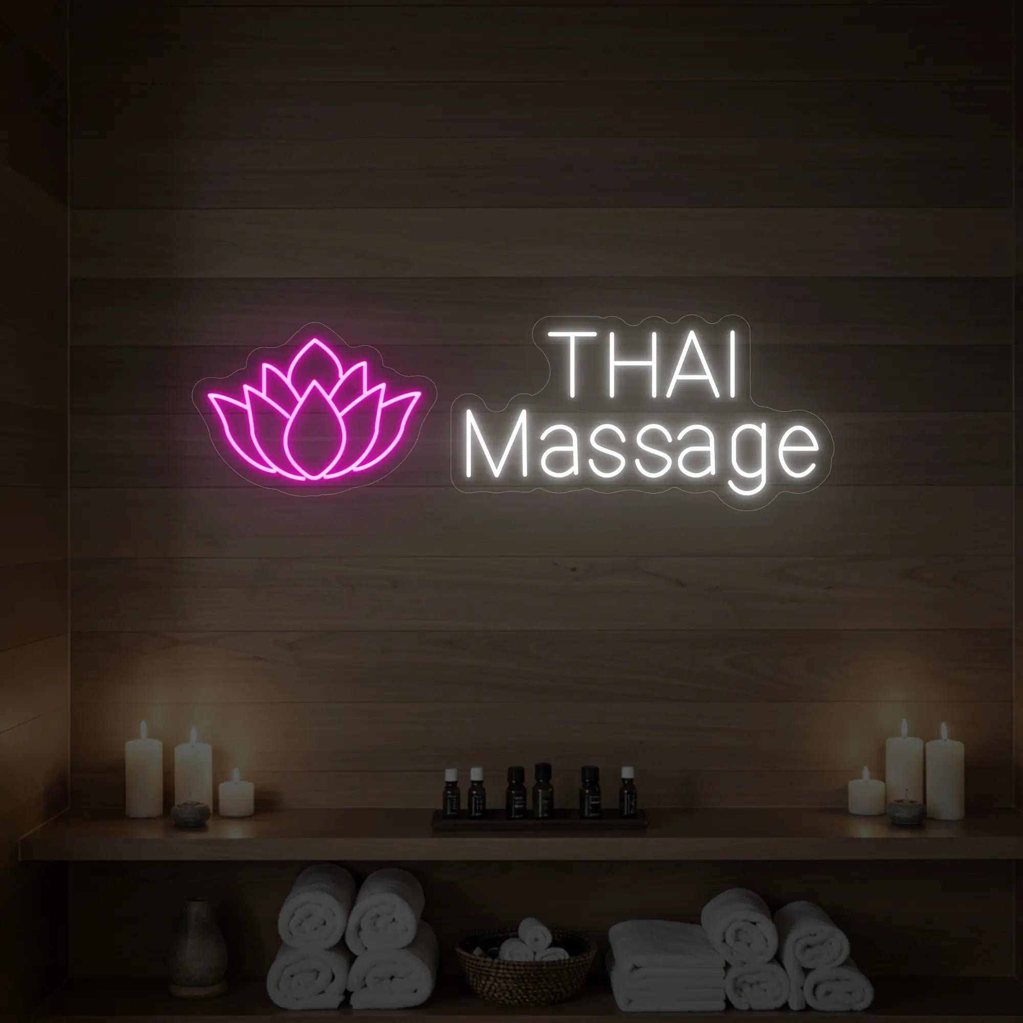 Photo of the 'Thai Massage' neon sign glowing in light pink against a styled interior wall.
