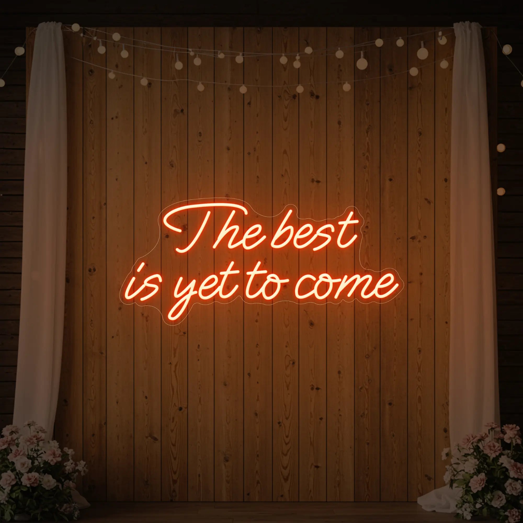 'The Best Is Yet To Come' neon sign glowing in golden yellow against a styled interior wall.