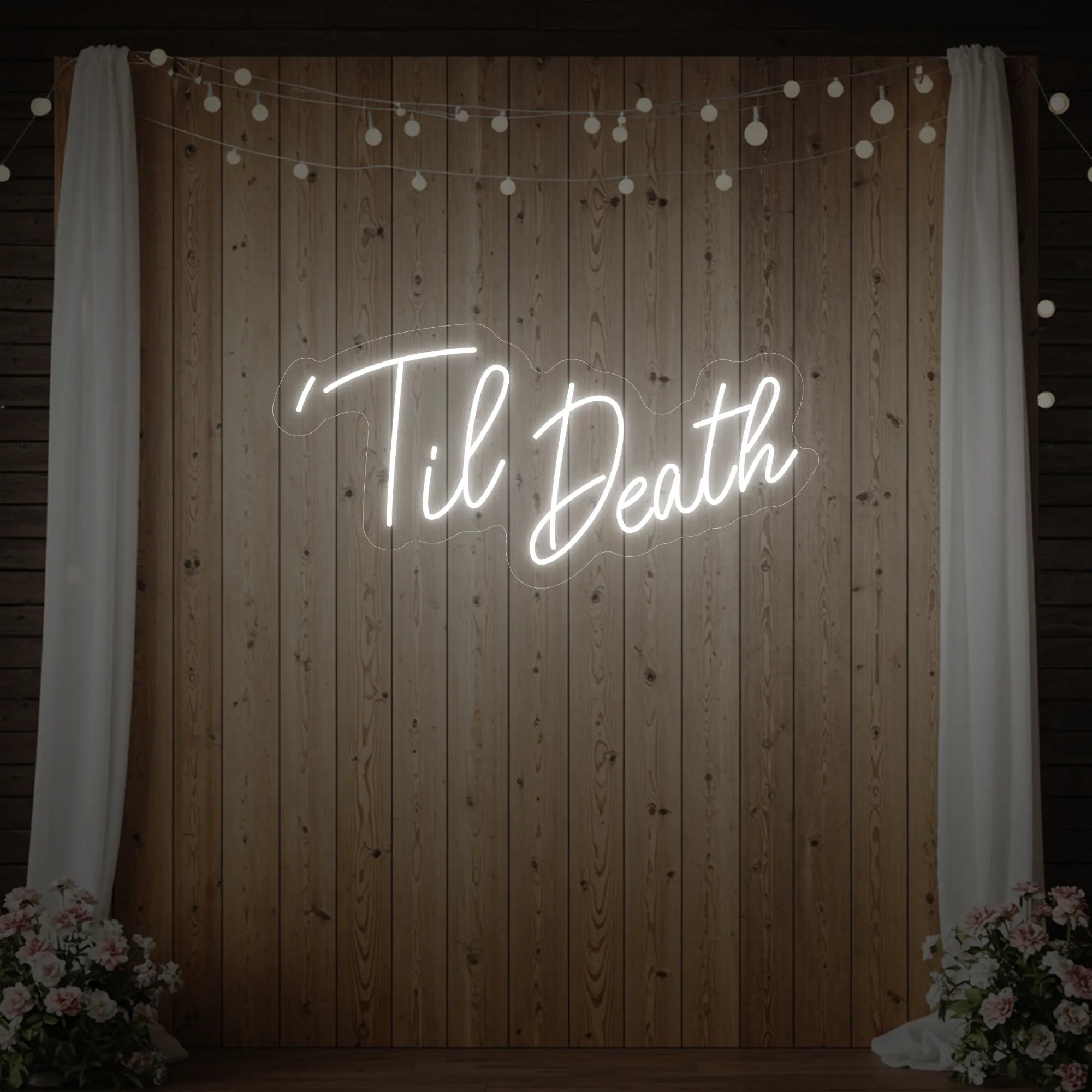 ''Til Death' neon sign glowing in cool white against a styled interior wall.