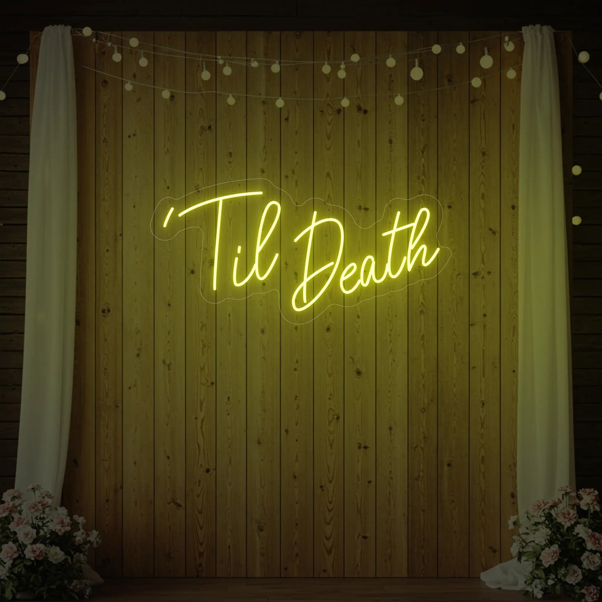 ''Til Death' neon sign glowing in lemon yellow against a styled interior wall.