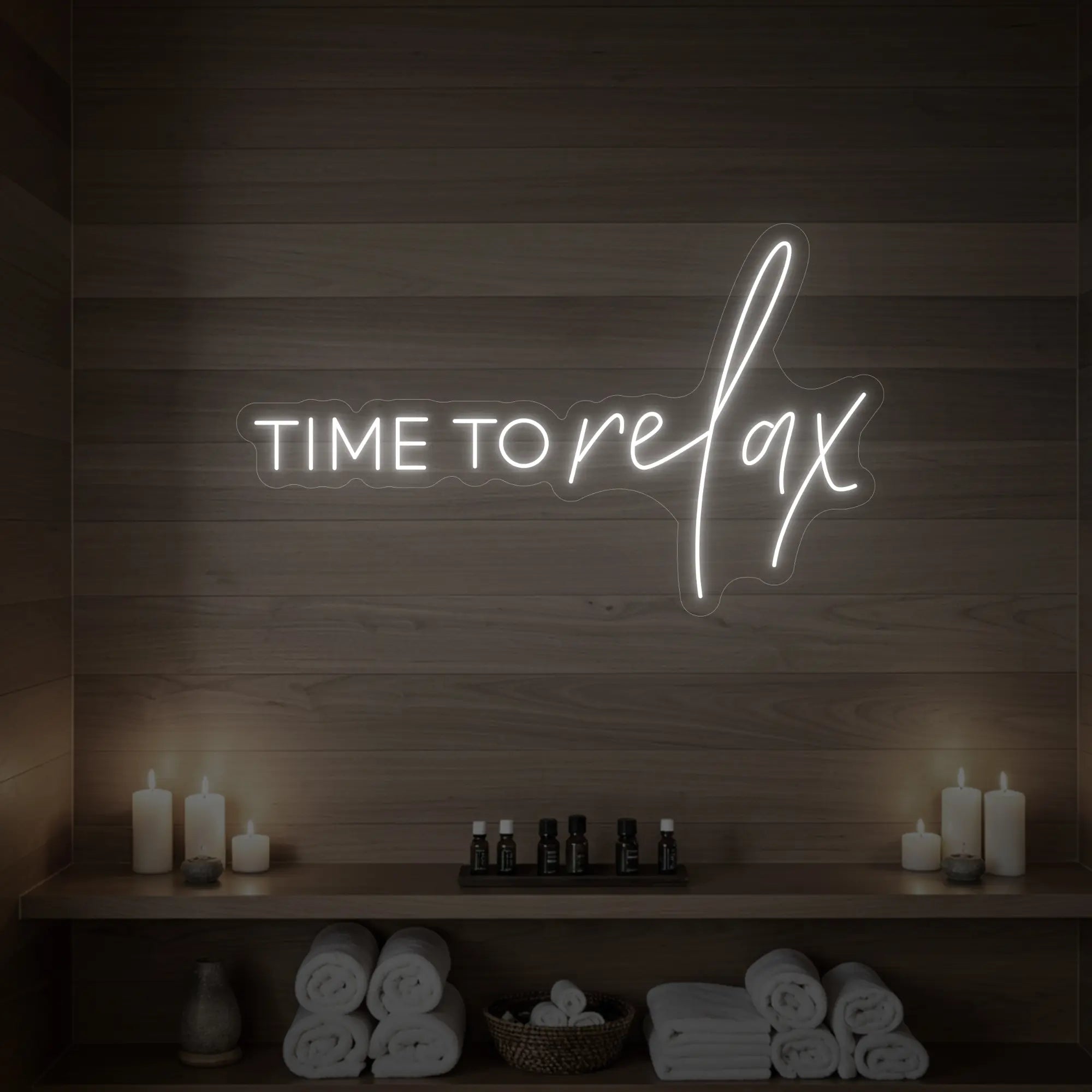 Photo of the 'TIME TO RELAX' neon sign glowing in cool white against a styled interior wall.