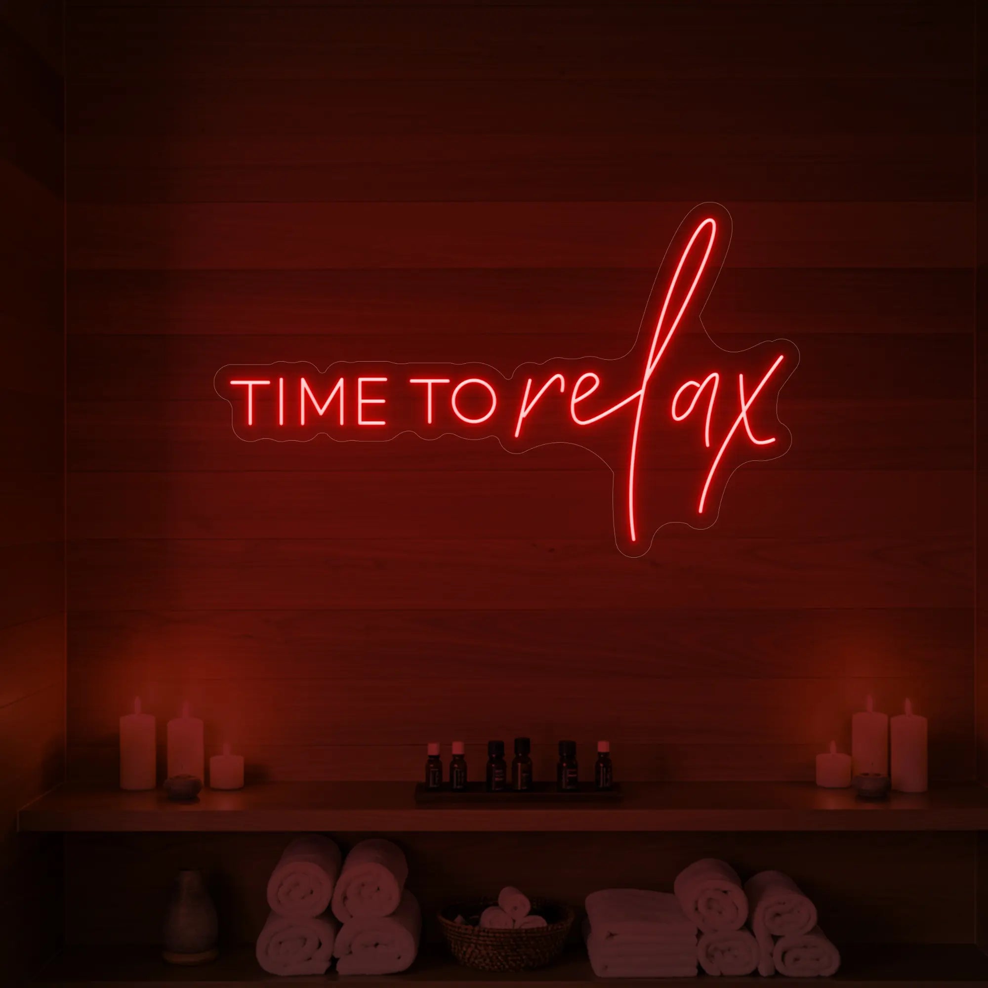 Photo of the 'TIME TO RELAX' neon sign glowing in red against a styled interior wall.