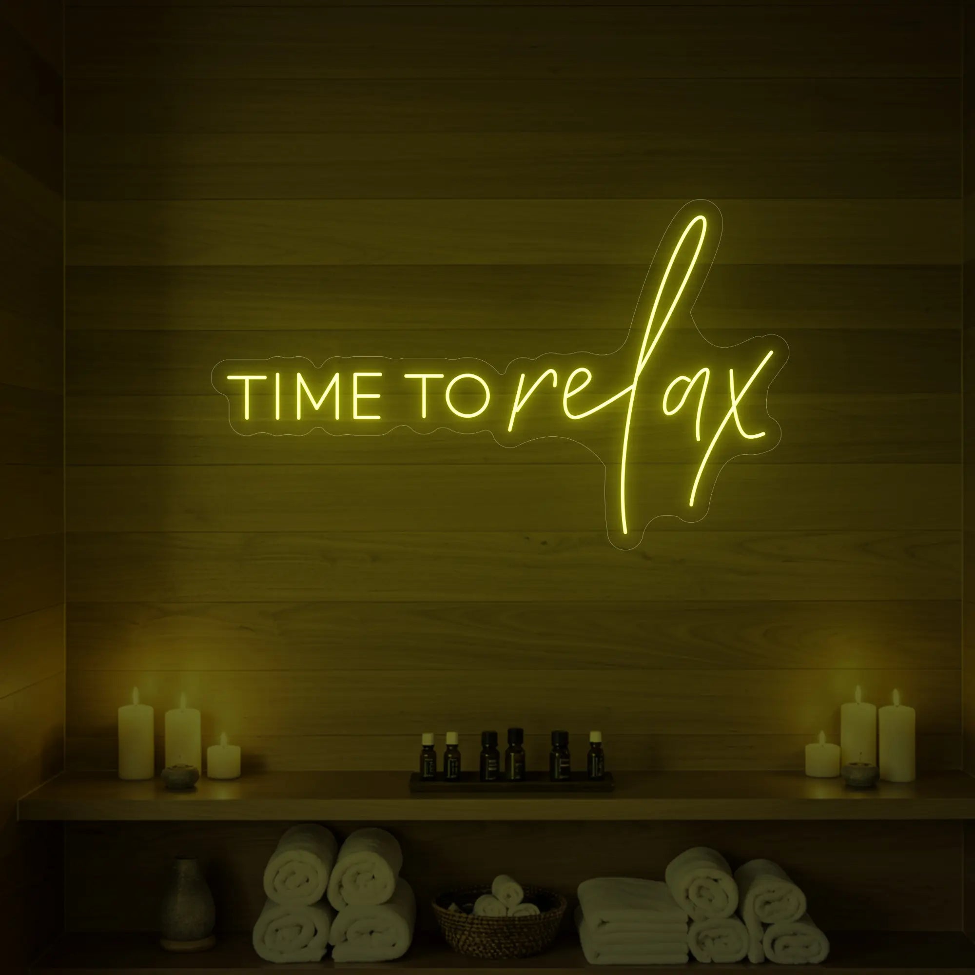 Photo of the 'TIME TO RELAX' neon sign glowing in lemon yellow against a styled interior wall.