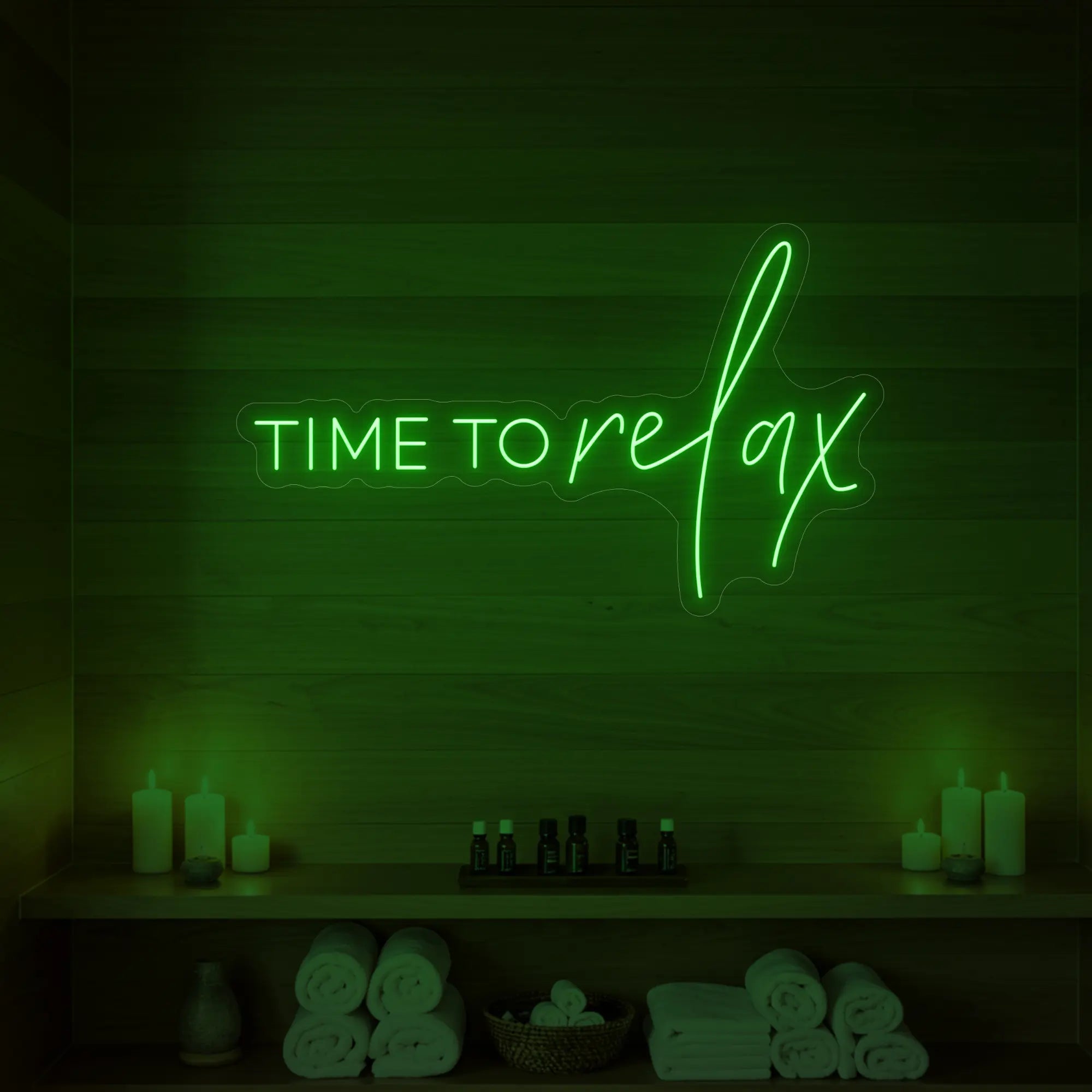 Photo of the 'TIME TO RELAX' neon sign glowing in green against a styled interior wall.