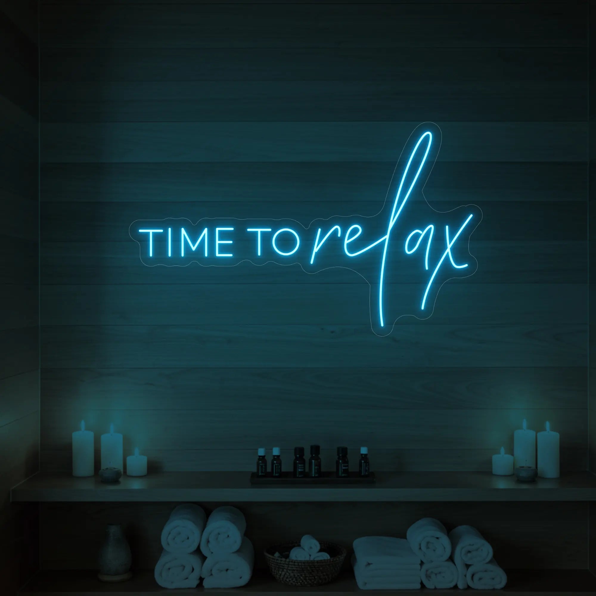 Photo of the 'TIME TO RELAX' neon sign glowing in ice blue against a styled interior wall.